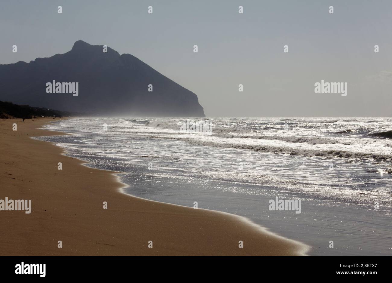 The silhouetted outline of Mount Circeo, seen from Torre Paola, at the southernmost end of Sabaudia Beach, Circeo National Park; Lazio, Italy Stock Photo