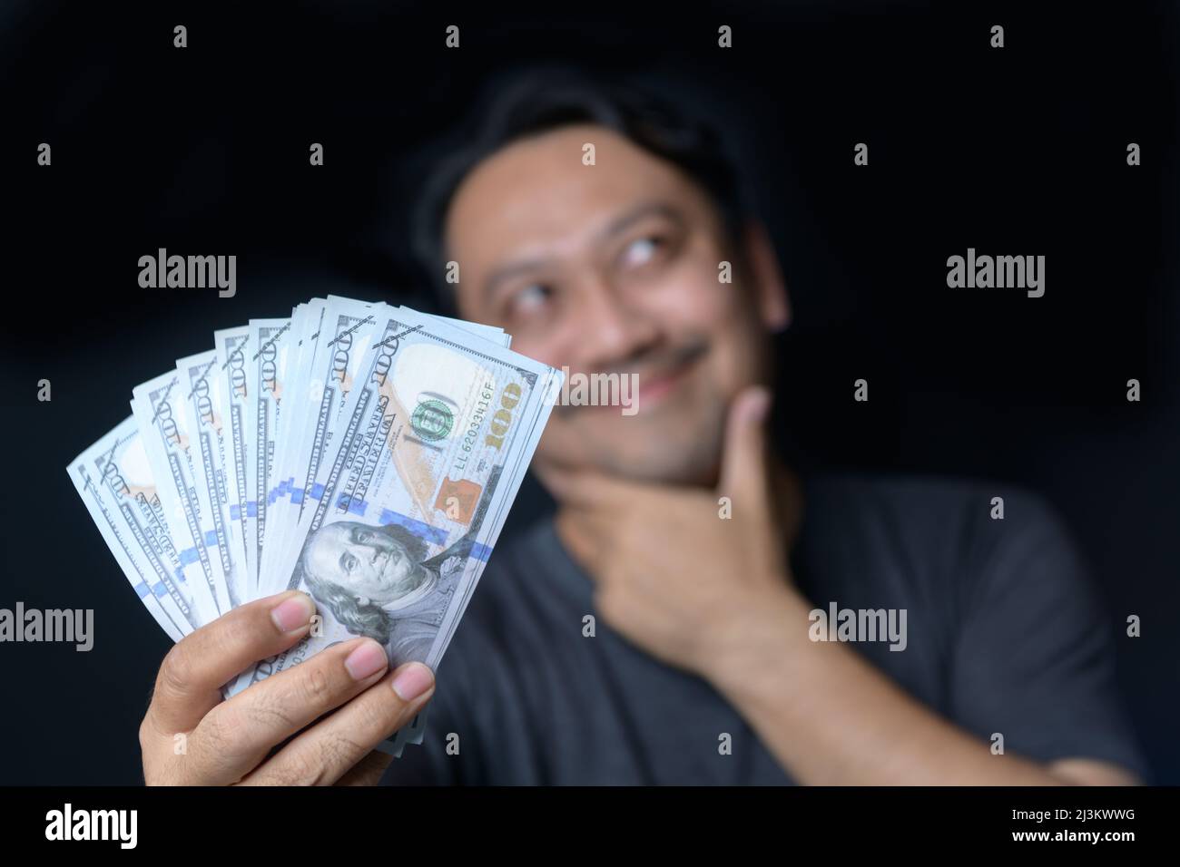 Rich Middle man holding US dollar and planning to invest the money  elsewhere. online bitcoin trading or cryptocurrency trading concept Stock  Photo - Alamy