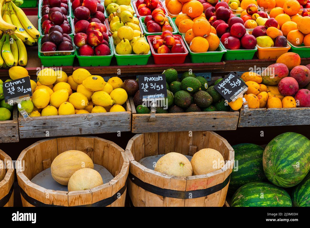 Fresh produce in a colourful display for sale at a supermarket with labels and prices in the French language; Montreal, Quebec, Canada Stock Photo