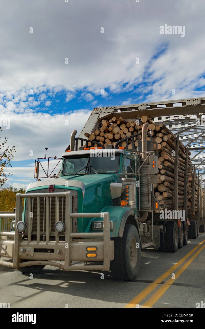 Logging truck going through bridge on BC Highway 97; Quesnel, British Columbia, Canada Stock Photo