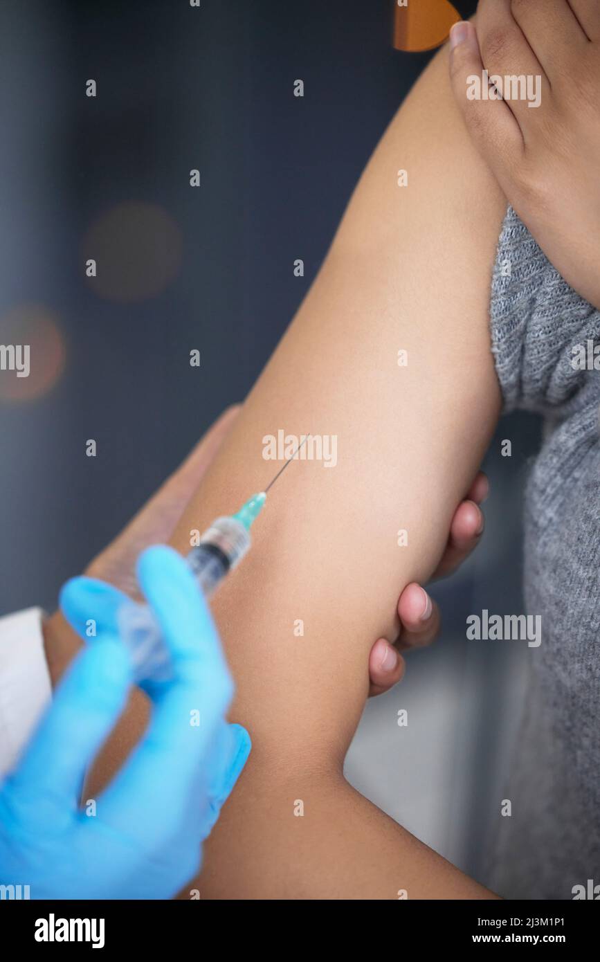 .. Shot of a woman receiving an injection at a Covid-19 vaccination ...