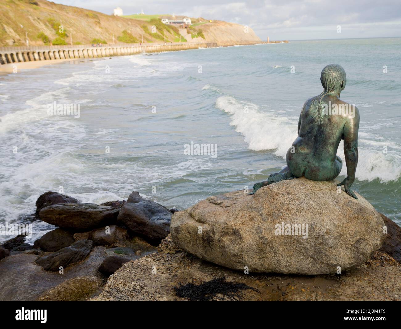Bronze statue of a mermaid by Cornelia Parker gazing over the horizon, Folkestone Harbour; Folkestone, Kent, England Stock Photo