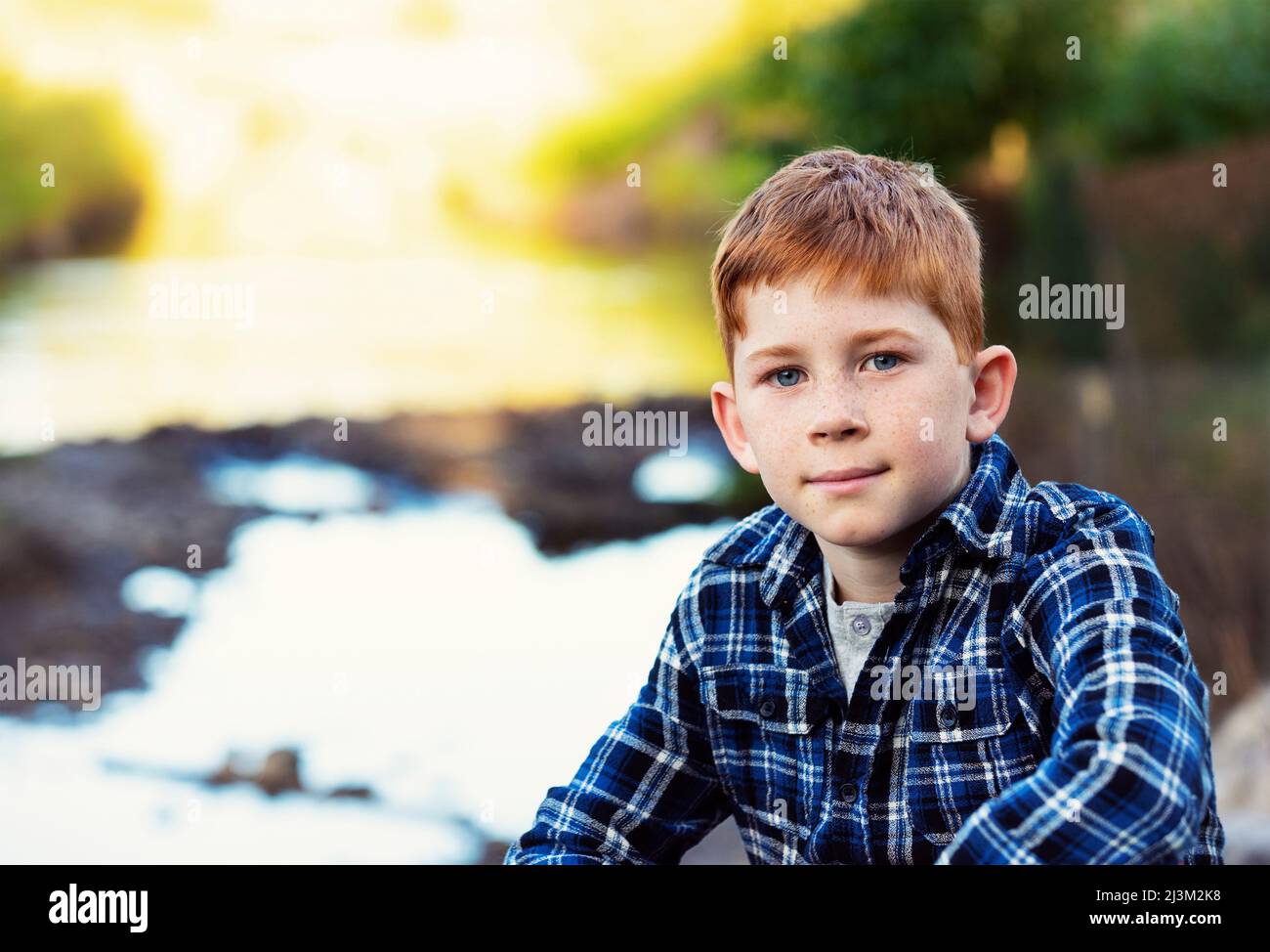 Outdoor portrait of a boy with red hair, freckles and blue eyes; Edmonton, Alberta, Canada Stock Photo