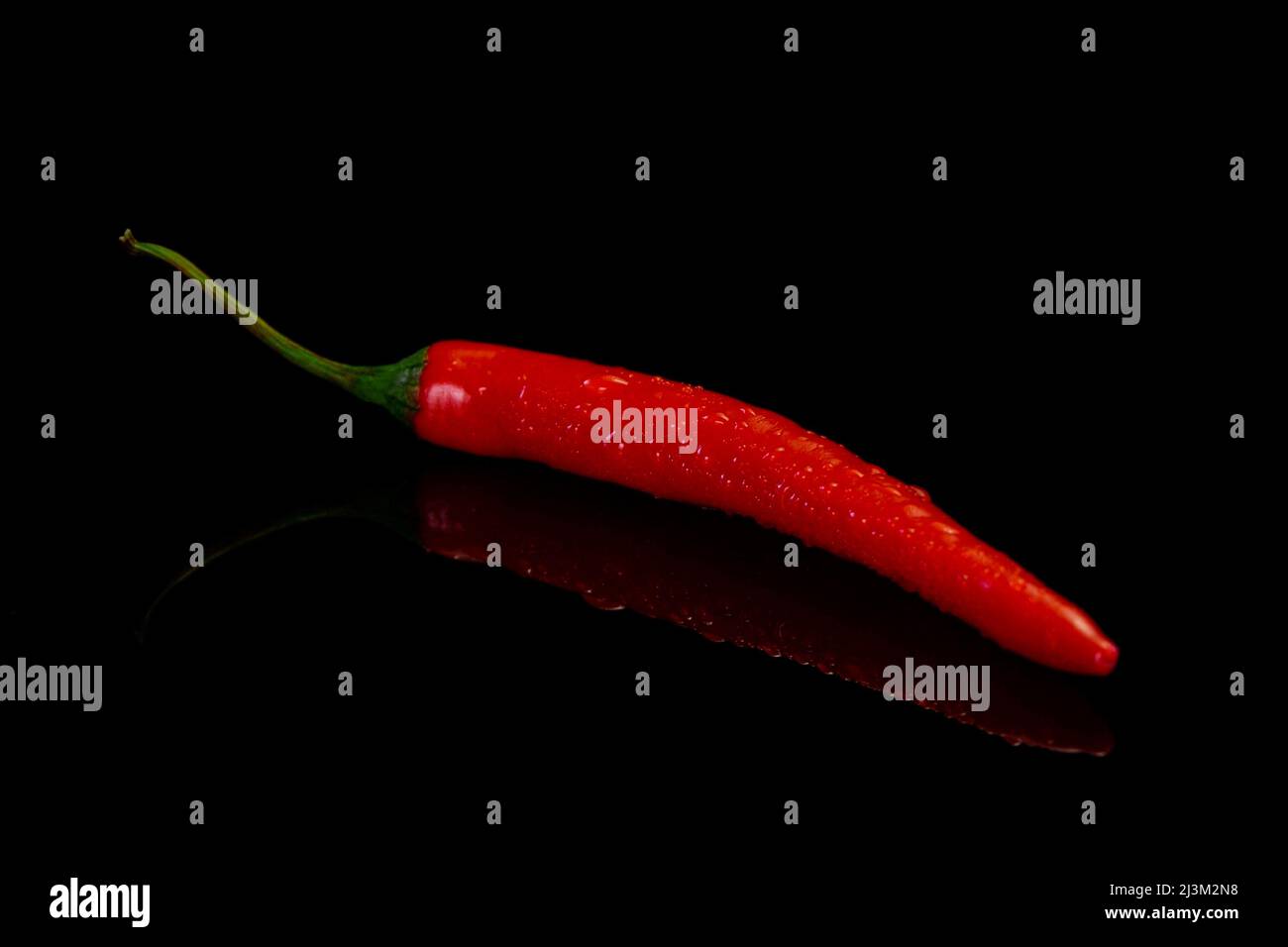 Chilli peppers on a black background. Fresh red hot chilli pepper. Stock Photo