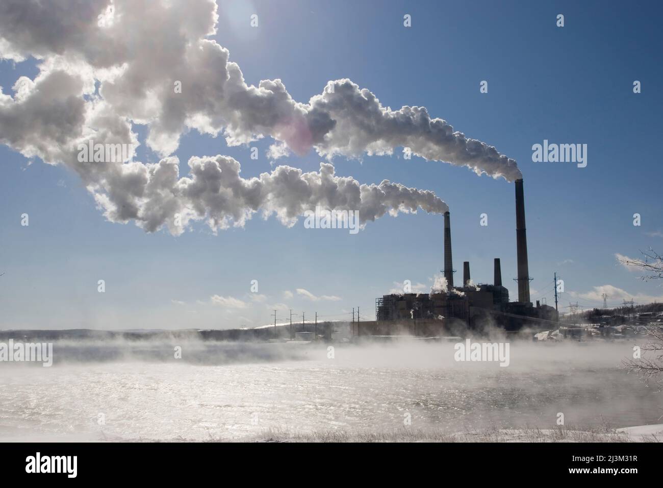 Coal fired power plant in winter with emissions blowing downwind; Mount