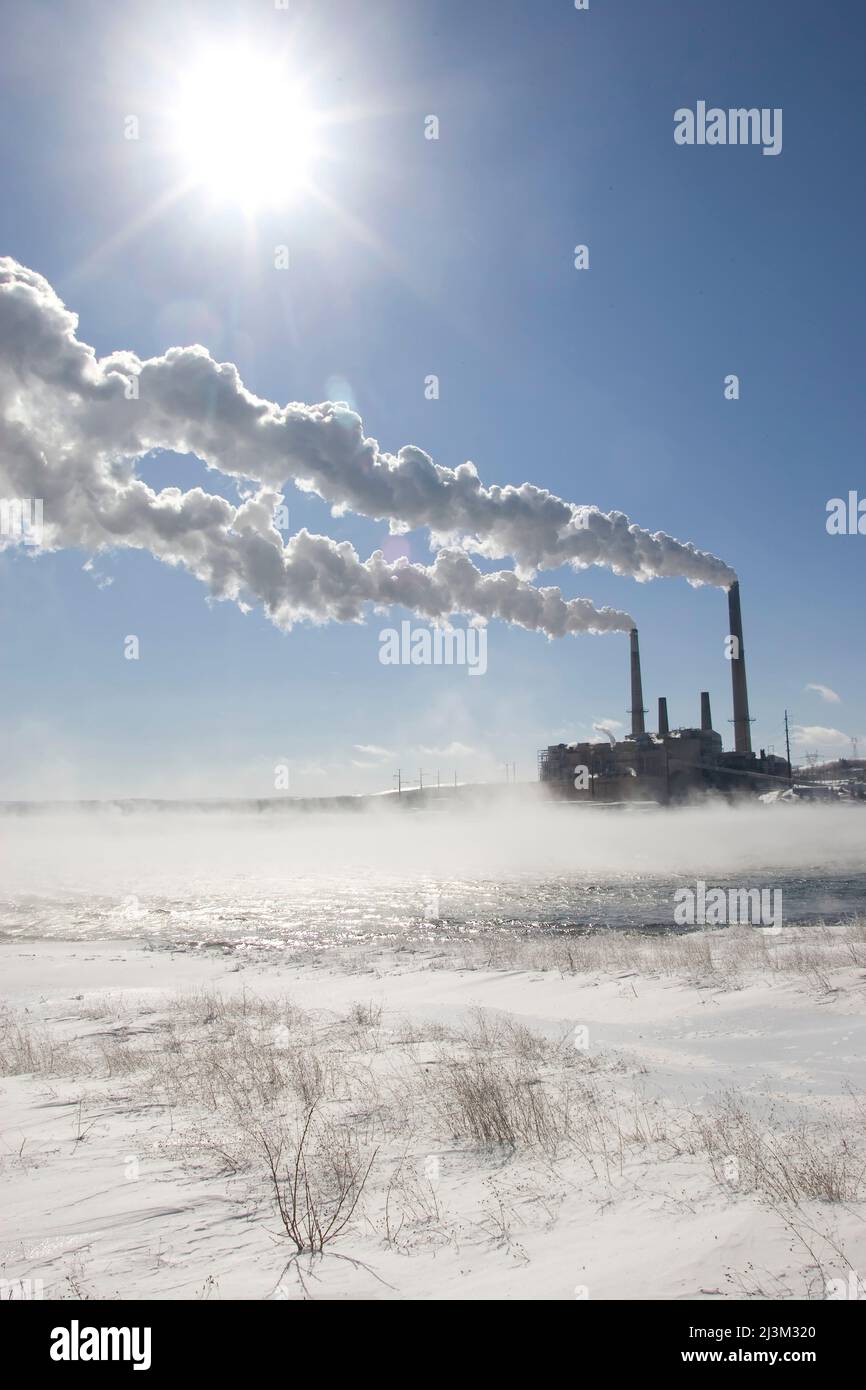 Coal fired power plant in winter with emissions blowing downwind; Mount