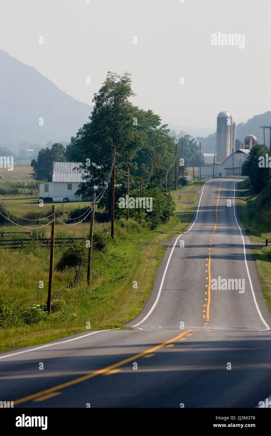 A country road through farmland.; Hardy County, West Virginia Stock
