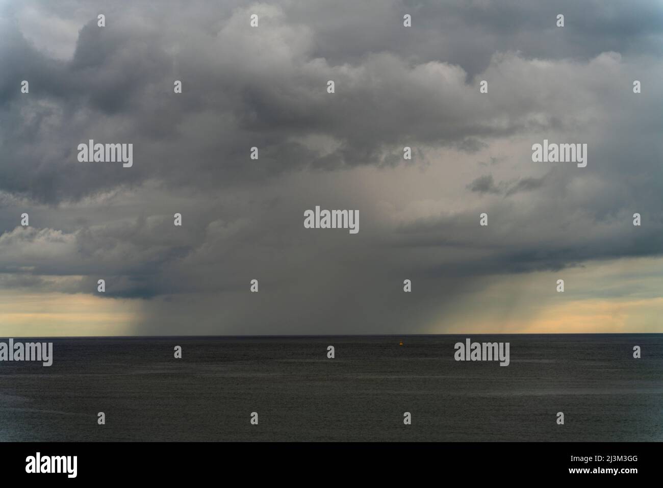 Storm clouds and rainfall over the vast open ocean; South Shields, Tyne and Wear, England Stock Photo