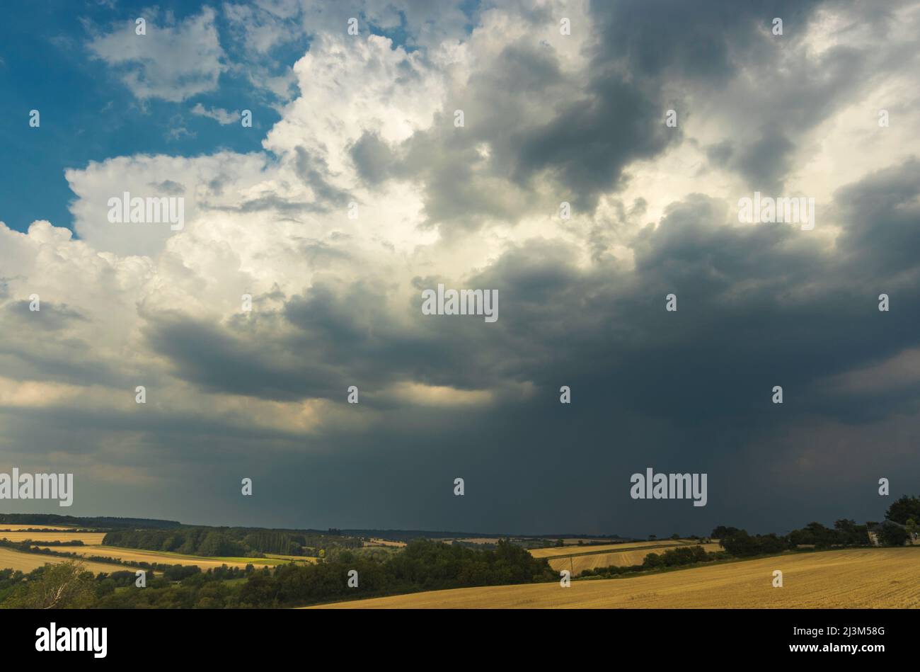A cluster of ominous looking clouds marches over the English countryside; Burford, Oxfordshire, England Stock Photo