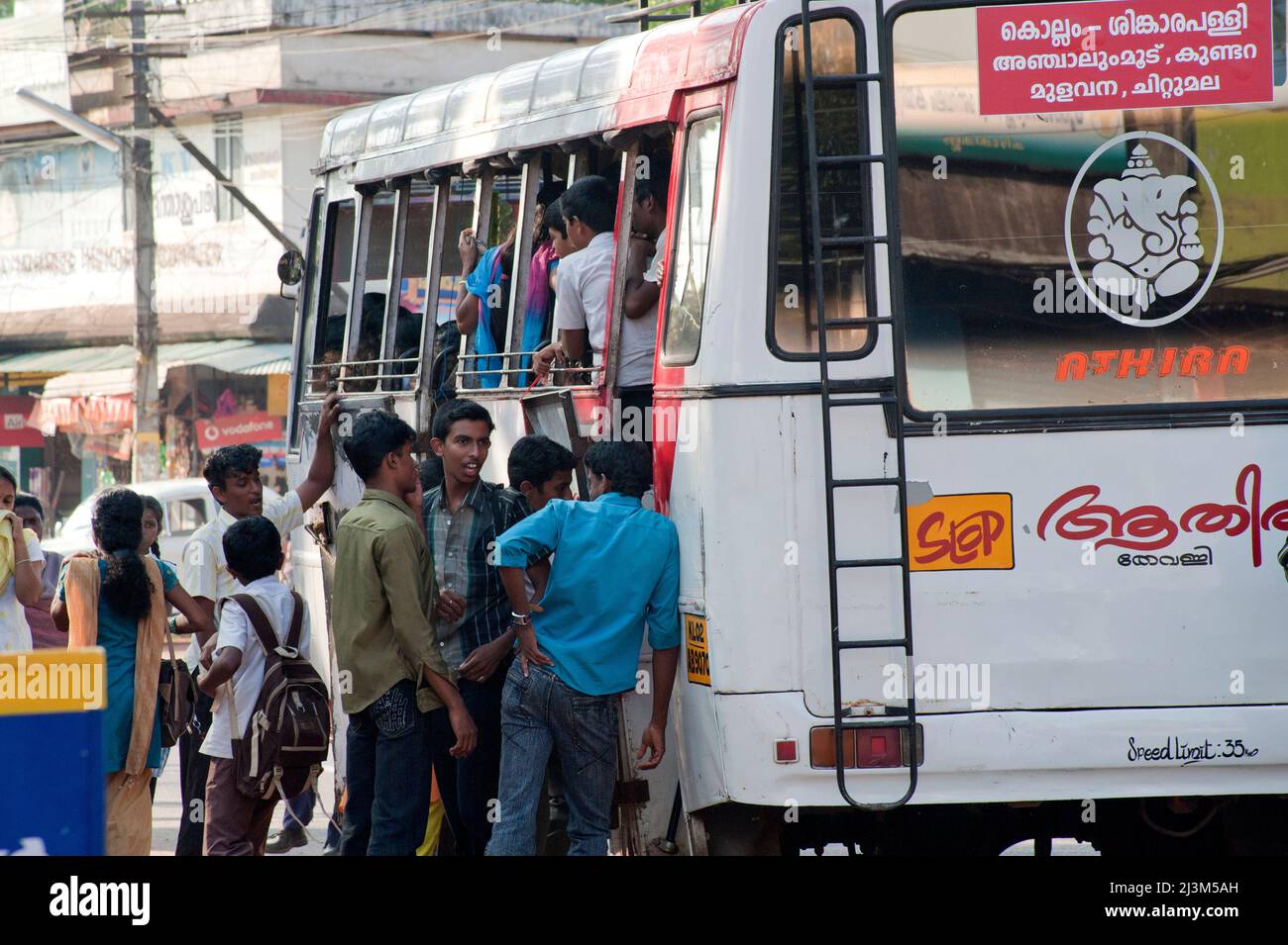 Passengers try to catch local transport bus on road at Chittumala