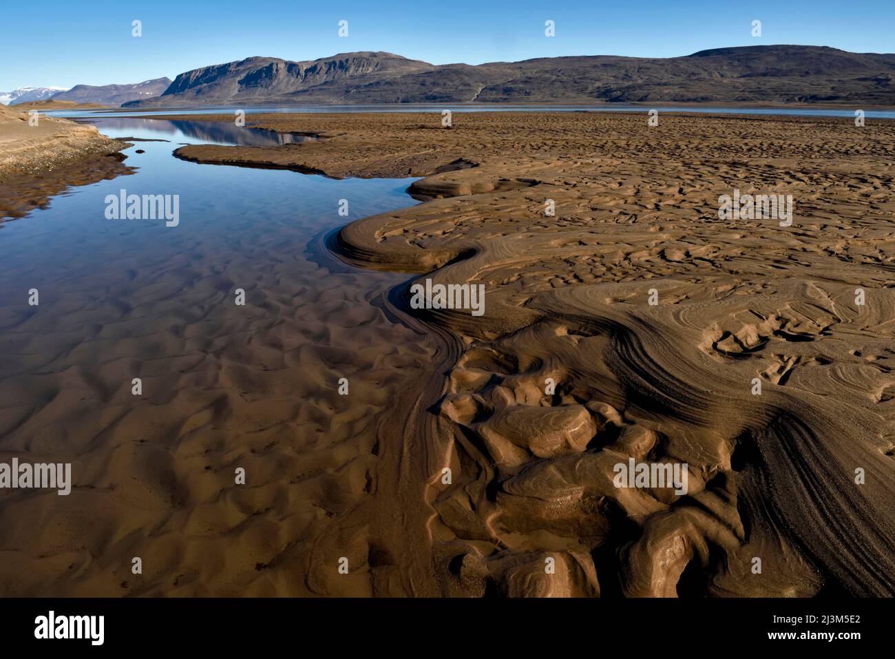 Mud formations carved out by the shallow waters of the southern inlet entering Lake Centrum So.; Greenland. Stock Photo