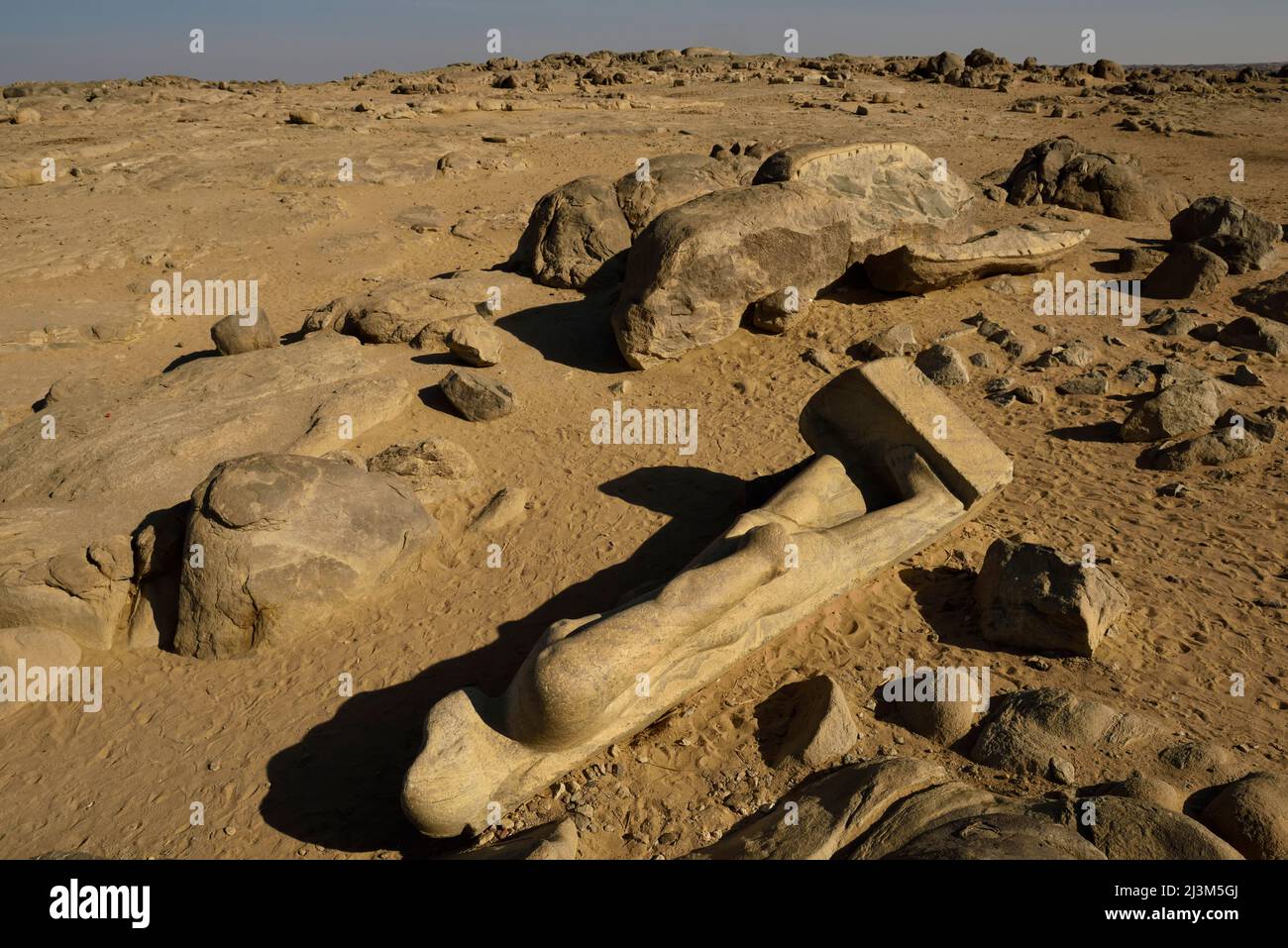 At Tumbus, a broken statue of king Taharqa from the Kustite period lies by the main road that follows the east bank of the Nile.; Kerma, Sudan, Egypt. Stock Photo