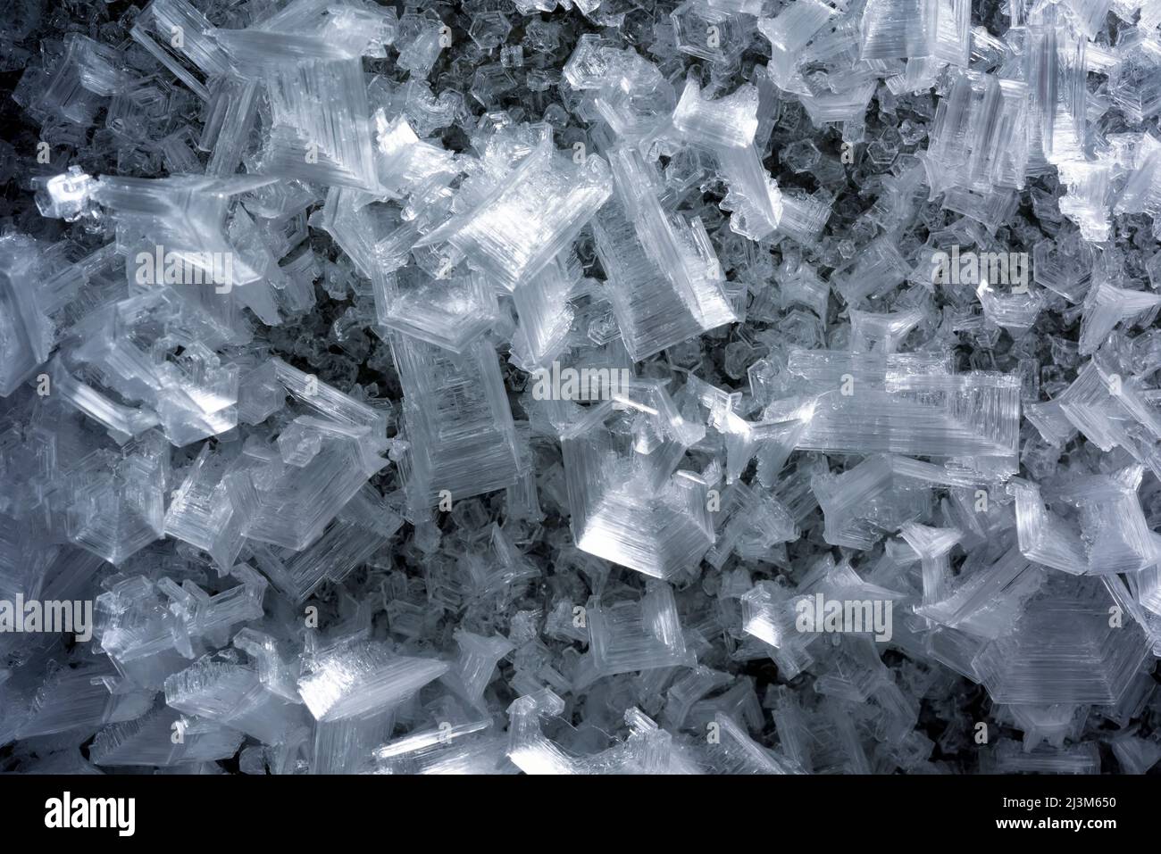 Detail of the giant ice crystals clinging to the walls and ceiling of The Crystal Palace cave.; Greenland. Stock Photo