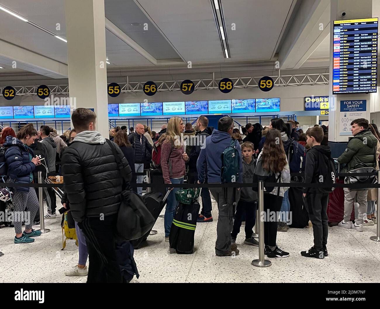 Passengers queue inside the departures area of Terminal 1 at Manchester ...