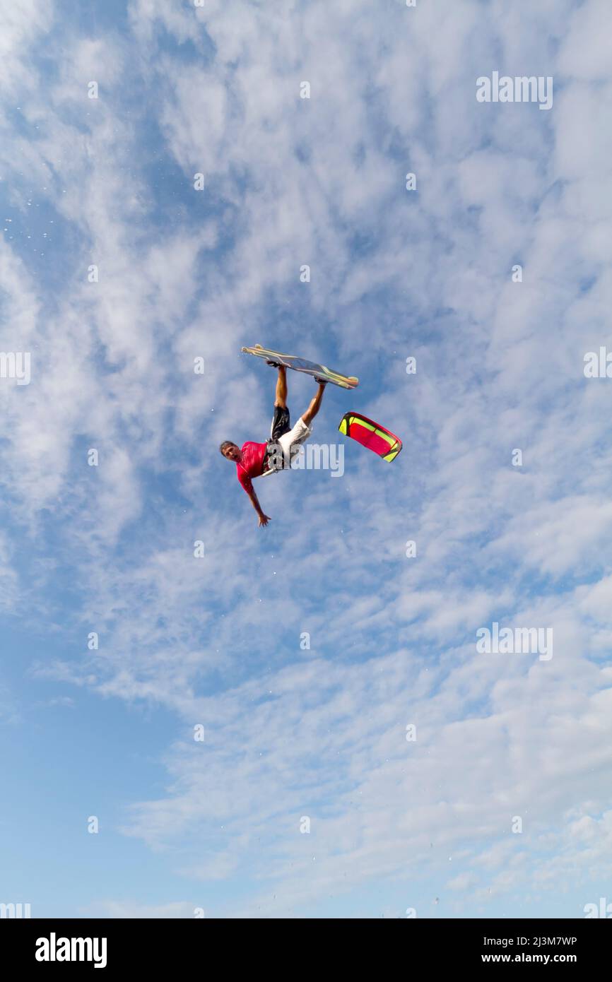 A pro kiteboarder jumps high over the Pamlico Sound.; Pamlico Sound, Nags Head, Outer Banks, North Carolina. Stock Photo