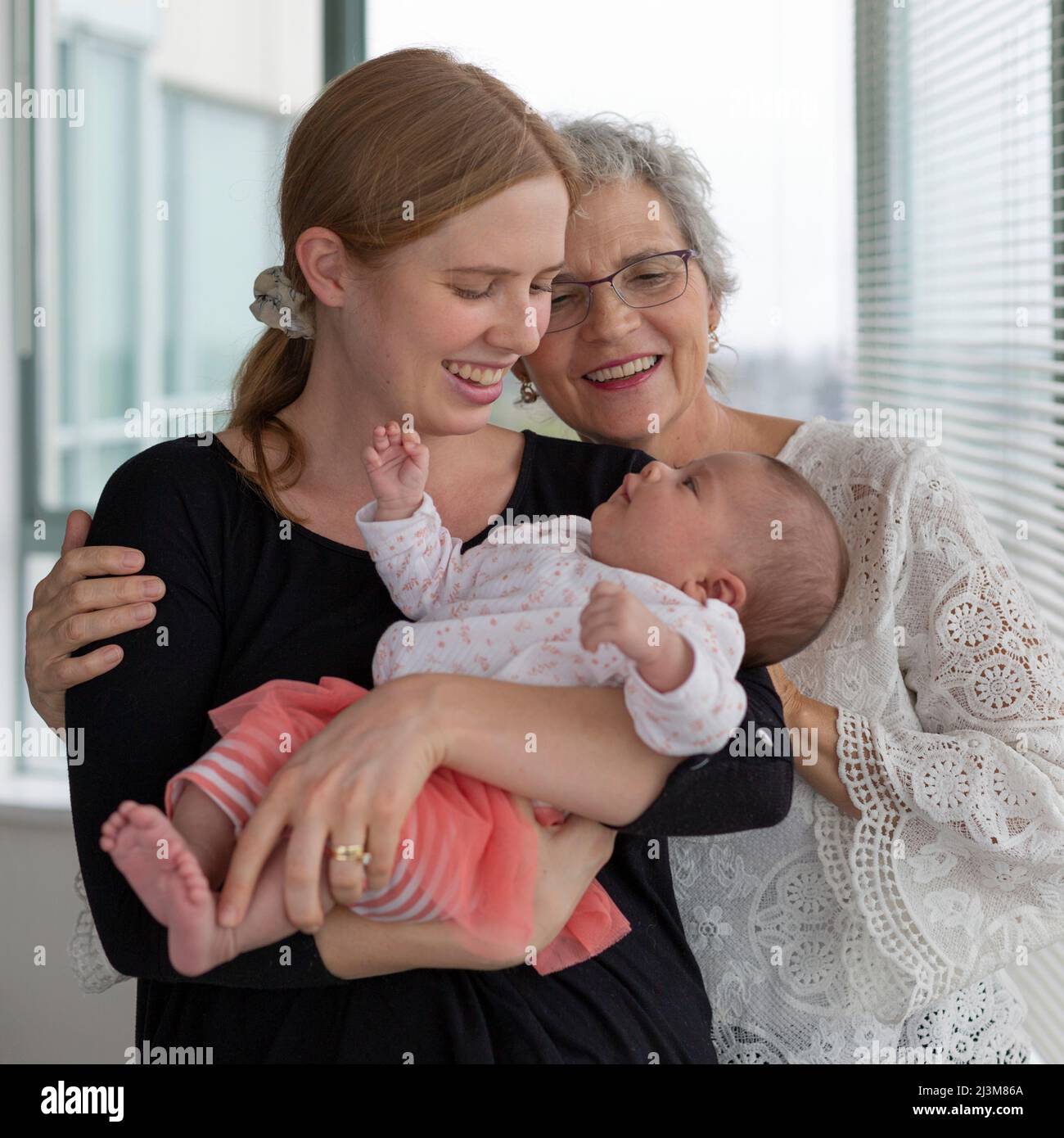 Portrait of three generations of women together at home; Surrey, British Columbia, Canada Stock Photo