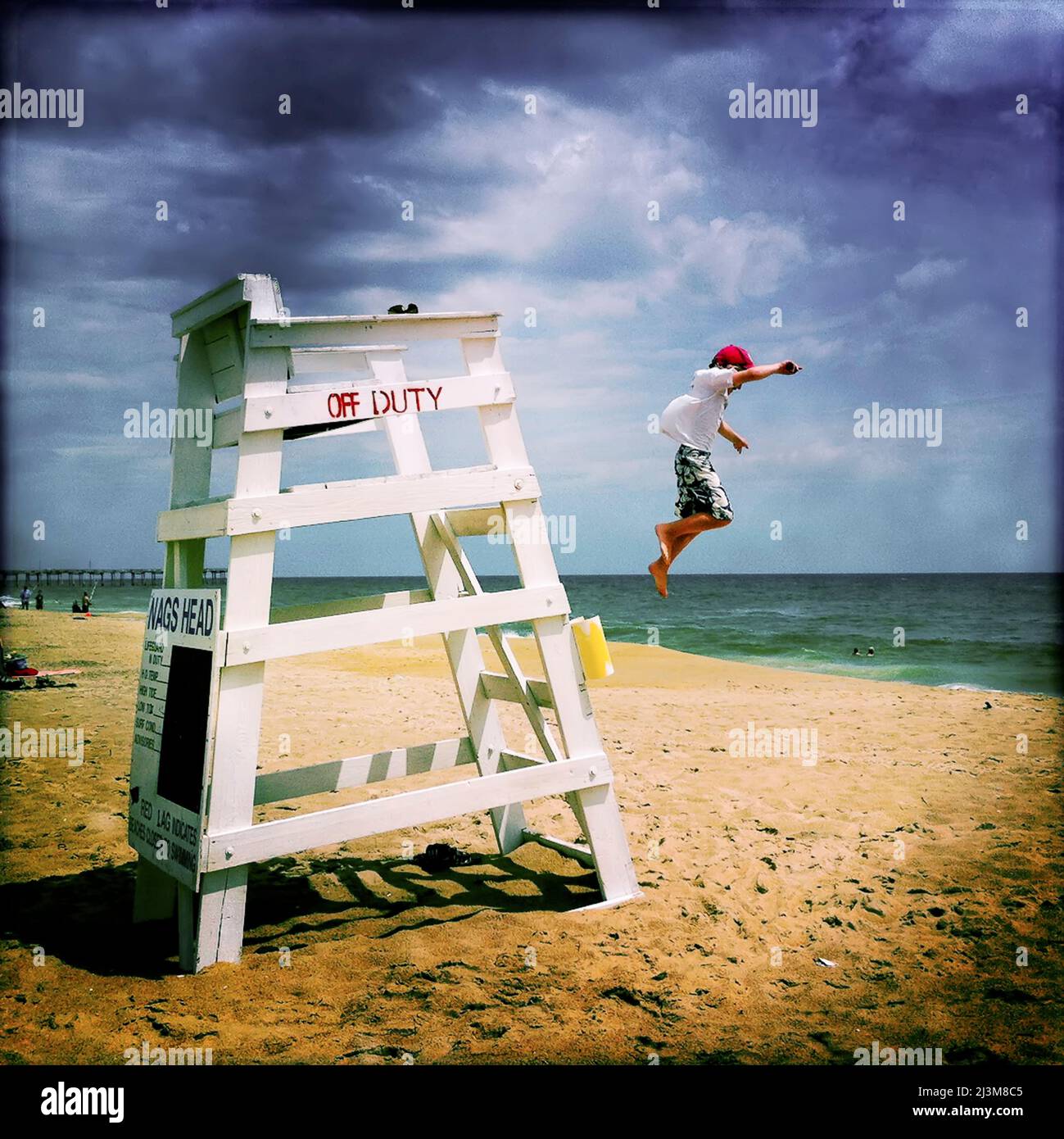 An eight year old boy jumps from an off duty lifeguard stand.; Nags