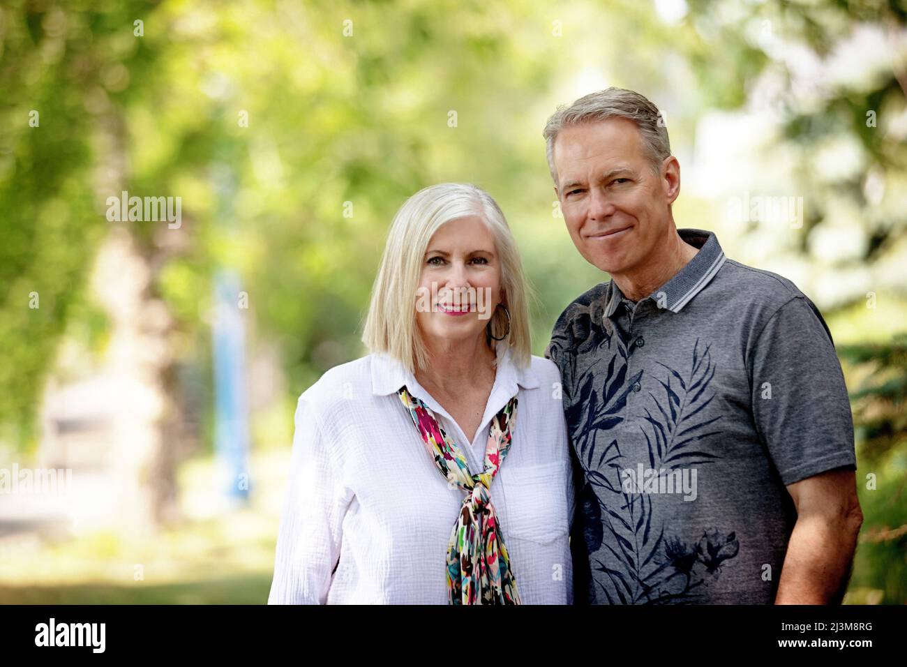 Outdoor portrait of a mature couple in a park; Edmonton, Alberta, Canada Stock Photo