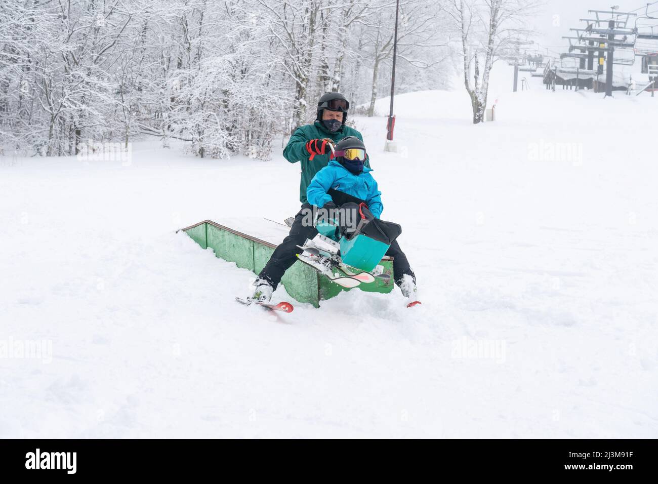 Adaptive skiing for a girl with Ullrich Congenital Muscular Dystrophy, at a ski resort with an instructor Stock Photo