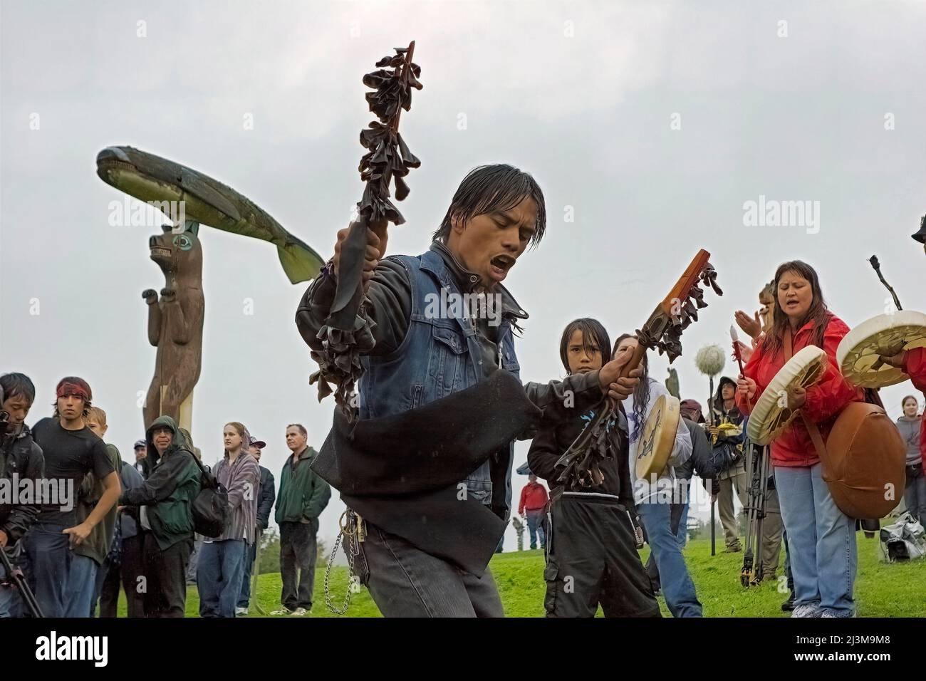 Native Alaskans celebrate a historic totem raising. Rain did not stop the celebrations of dancing and singing that followed a historic totem raisin... Stock Photo