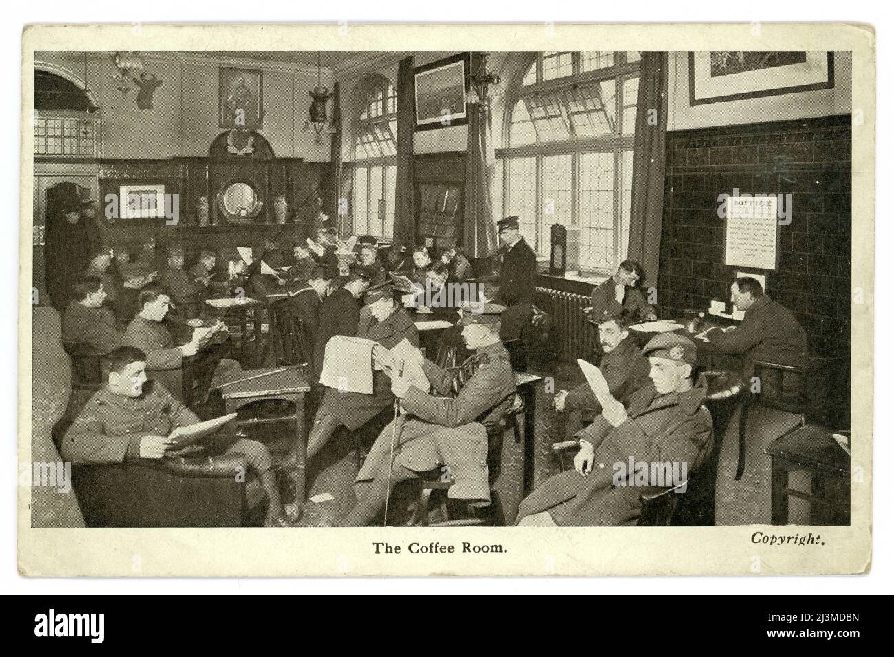 Original WW1 era postcard of The Coffee Room at the Union Jack Club, 91A Waterloo Road, Lambeth, London, U.K. Both army and navy personnel can be seen relaxing and reading newspapers.  The Union Jack Club was opened in 1907 providing accommodation, a restaurant, meeting and reading rooms for servicemen whilst in London. It saw much use during both world wars. Postcard published by the Union Jack Club. circa 1915. Stock Photo