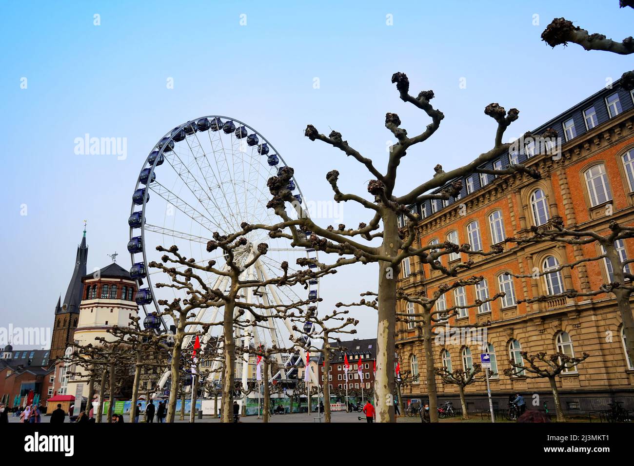 Scenery in Düsseldorf Old Town near Rhine river with historic castle tower, Ferris Wheel and old building. Stock Photo