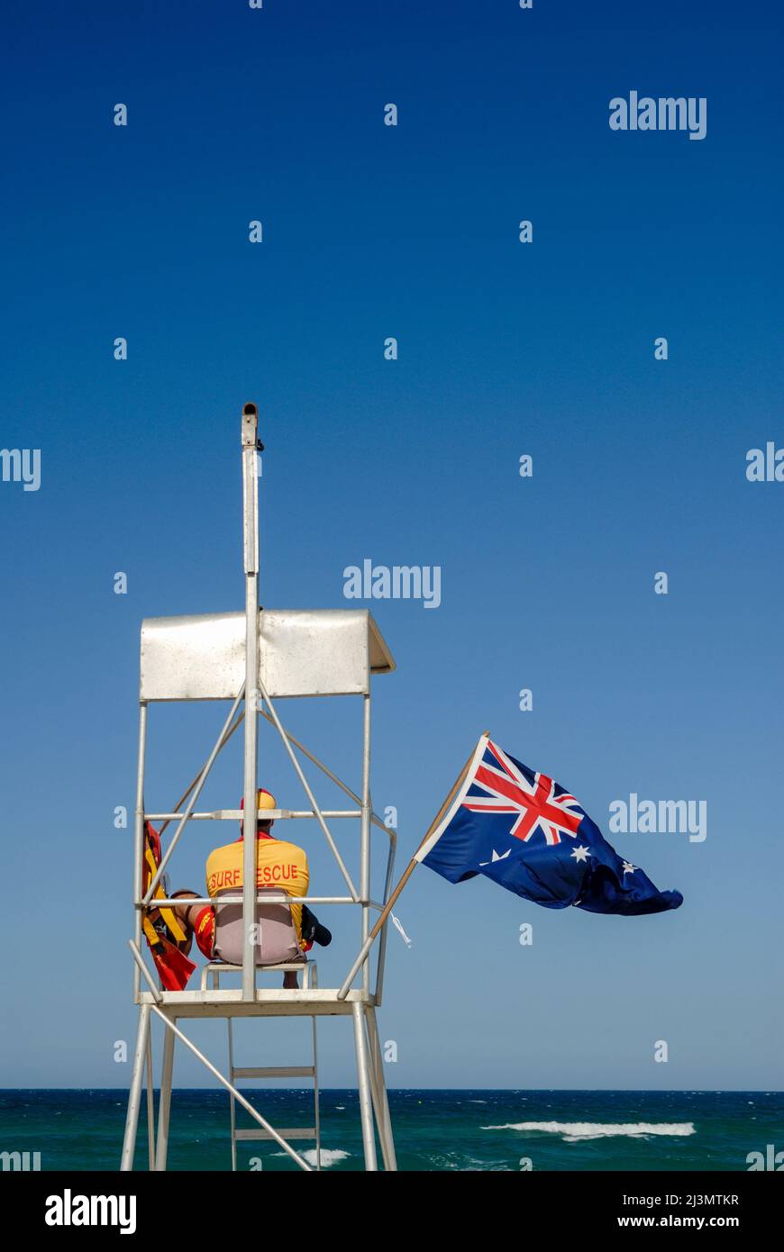 Surf lifesaver overseeing beach, watching for danger and people in distress. Stock Photo