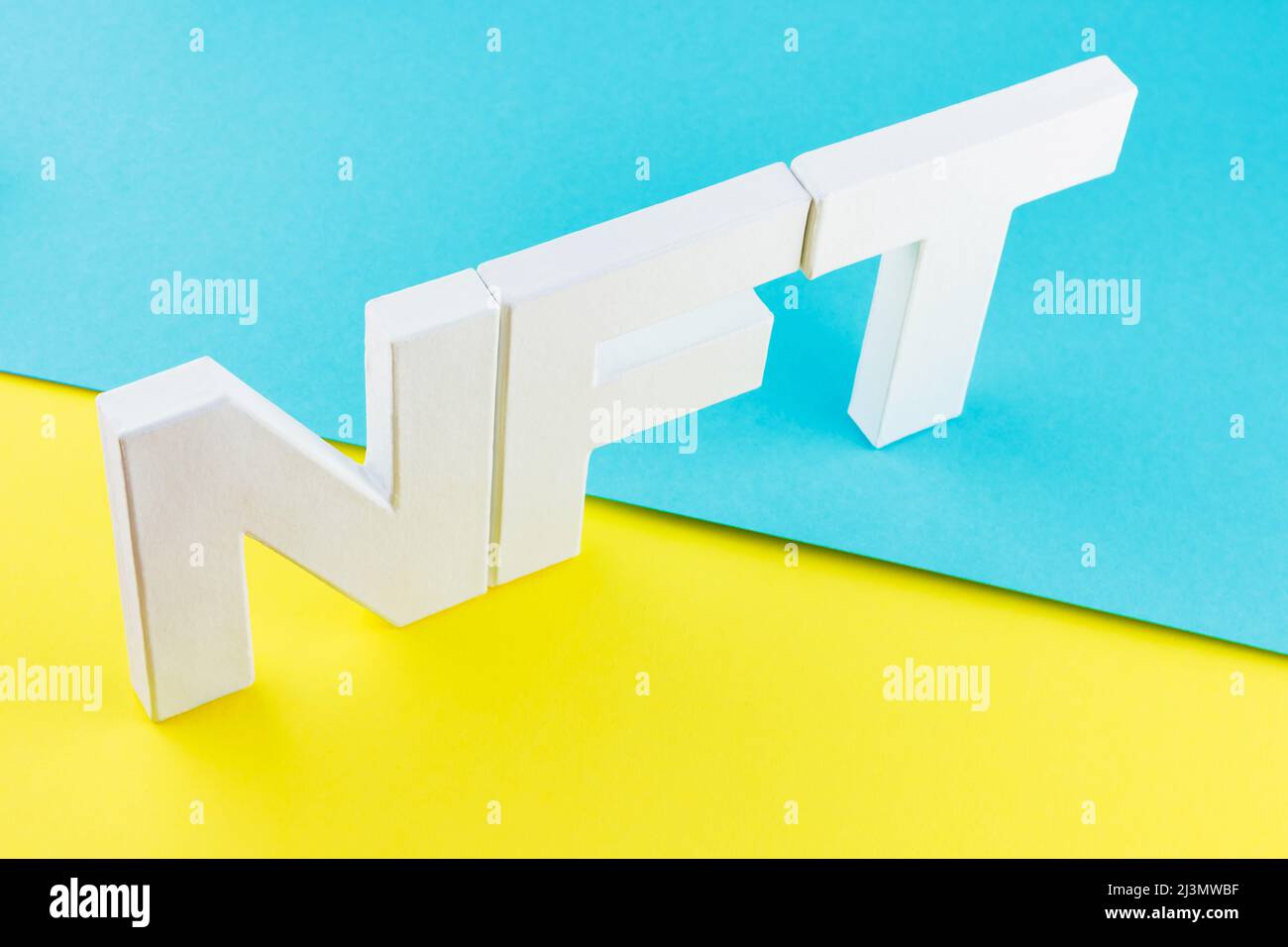 NFT inscription with white 3d letters on a blue-yellow background. Non ...