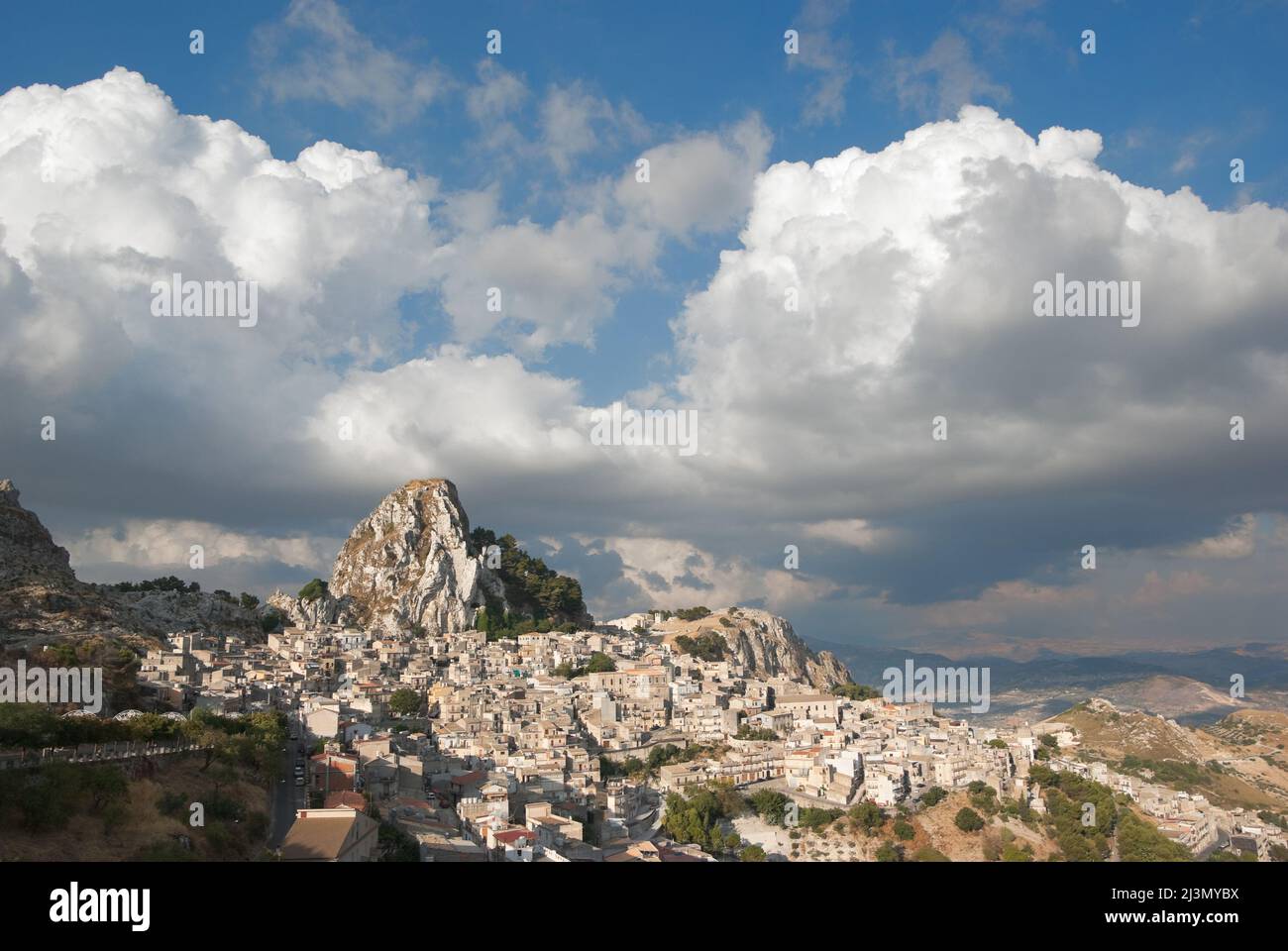 rock of Caltabellotta village in Sicily, in the background dramatic sky with big clouds Stock Photo