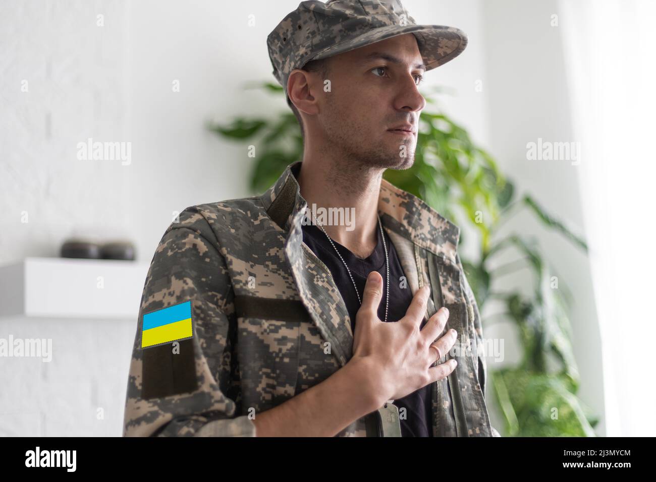 Ukrainian man warrior dressed in a military pixel uniform the yellow ...
