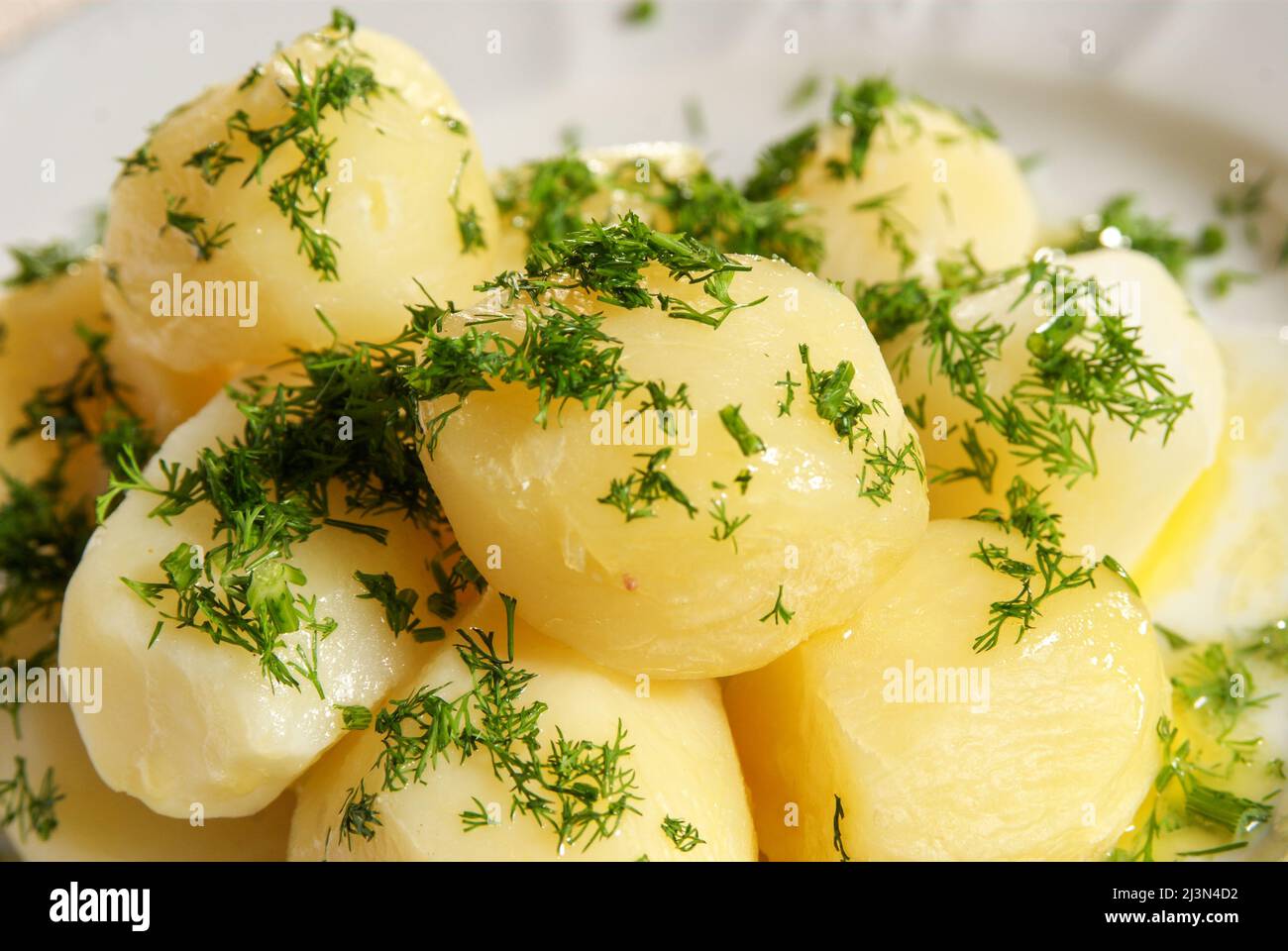 Boiled potato with parsley Stock Photo Alamy