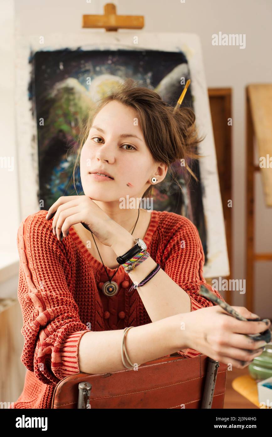 Portrait of beautiful woman artist with smile and positive emotion in