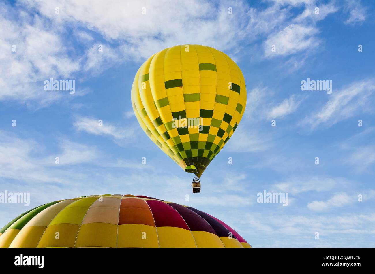 Colorful hot air balloon flying over blue sky Stock Photo - Alamy