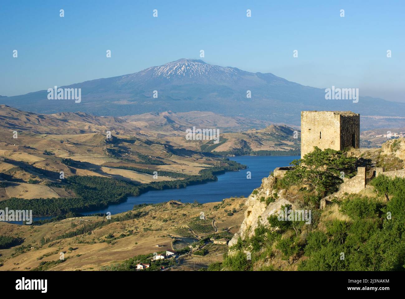 view from Agira on Old Tower and Pozzillo Lake, on background volcano Etna Stock Photo
