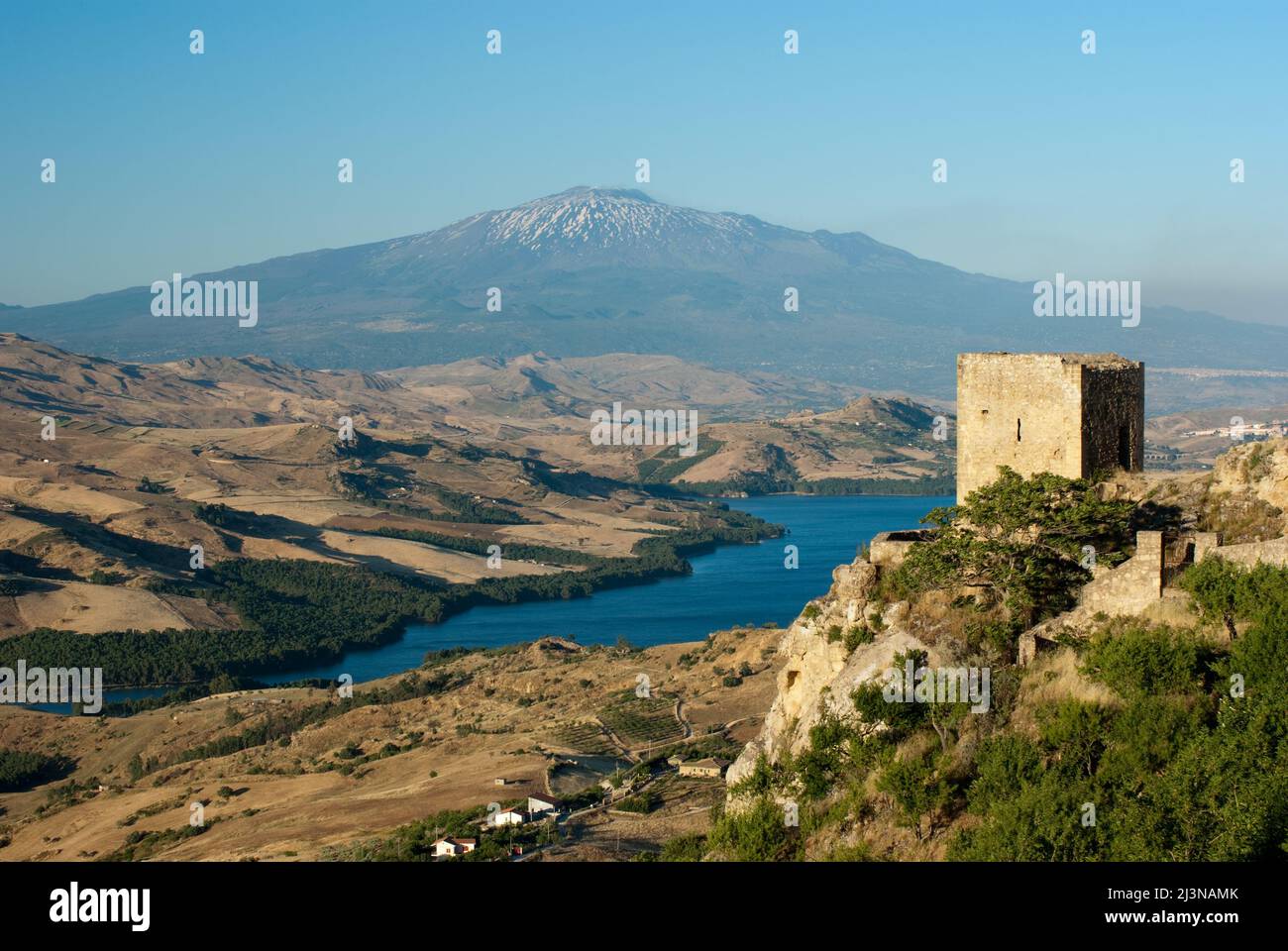 view of a tower of Agira on lake Pozzillo of Regalbuto and in background volcano Etna Stock Photo