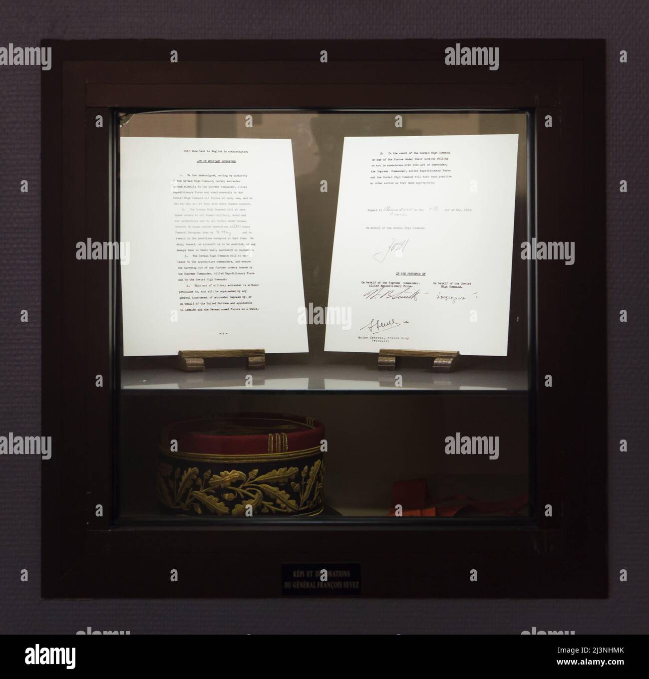 Facsimile of the German Instrument of Surrender signed in Reims on 7 May 1945 and the kepi of French general François Sevez on display in the Museum of the Surrender (Musée de la Reddition) in Reims, France. The first German Instrument of Surrender that ended World War II in Europe was signed at 02:41 Central European Time (CET) on 7 May 1945 in the building which serves now as the museum. French general François Sevez was present at the German surrender in Reims, and signed the German Instrument of Surrender as the official witness. Stock Photo