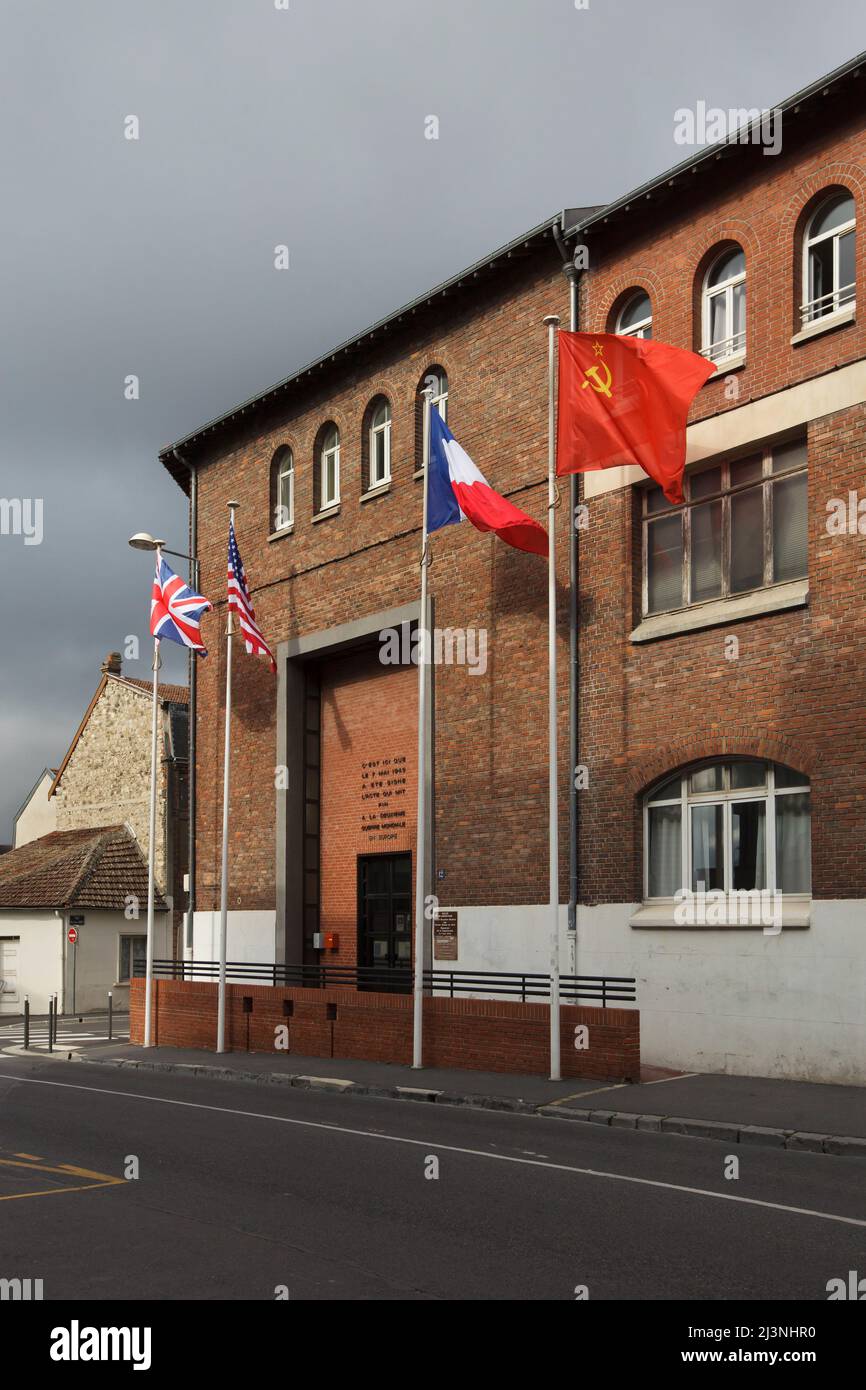 National flags of the United Kingdom, the United States of America, France and the Soviet Union wave at the entrance to the Museum of the Surrender (Musée de la Reddition) in Reims, France. The first German Instrument of Surrender that ended World War II in Europe was signed in this building at 02:41 Central European Time (CET) on 7 May 1945. Stock Photo