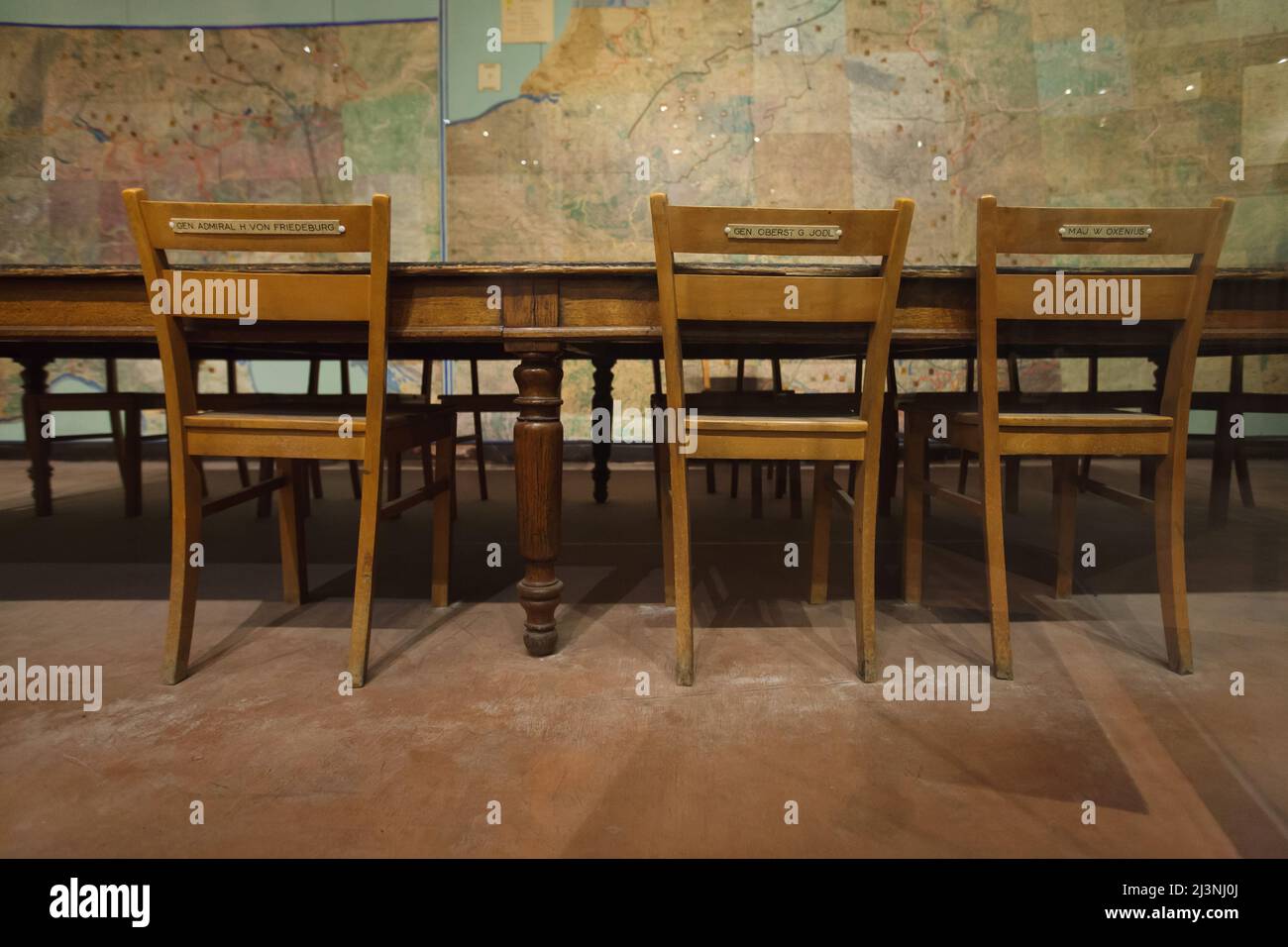 Chairs of the members of the German delegation in the Map Room also known as the War Room of the Supreme Headquarters Allied Expeditionary Force (SHAEF) in Reims, France. The first German Instrument of Surrender that ended World War II in Europe was signed in this room at 02:41 Central European Time (CET) on 7 May 1945. The historical room is served now as a part of the Museum of the Surrender (Musée de la Reddition). The chairs of Admiral Hans-Georg von Friedeburg, General Alfred Jodl and Major Wilhelm Oxenius are pictured from left to right. General Alfred Jodl served as the Chief of the Ope Stock Photo