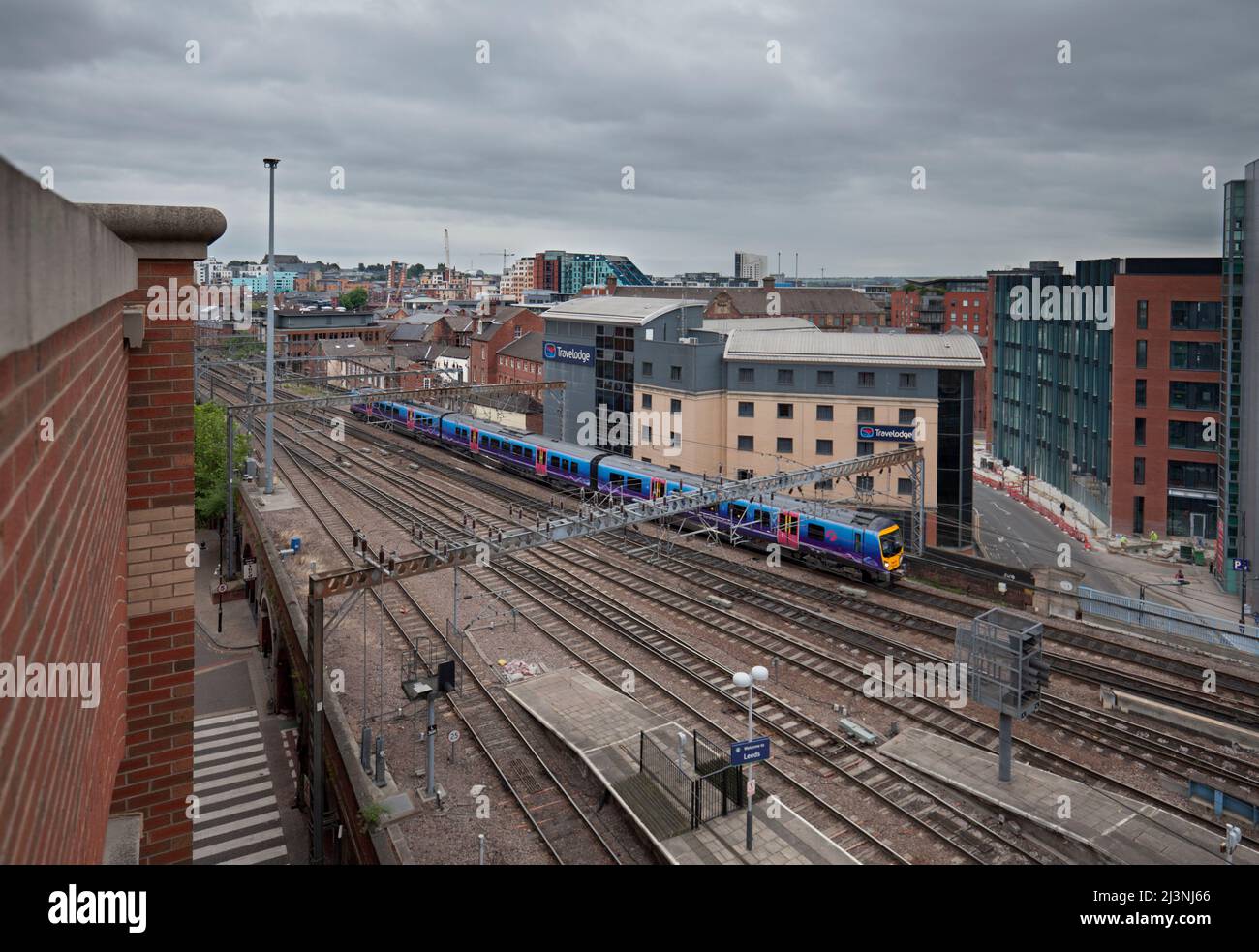 First Transpennine Express class 185  train running through the urban landscape in Leeds city centre Stock Photo
