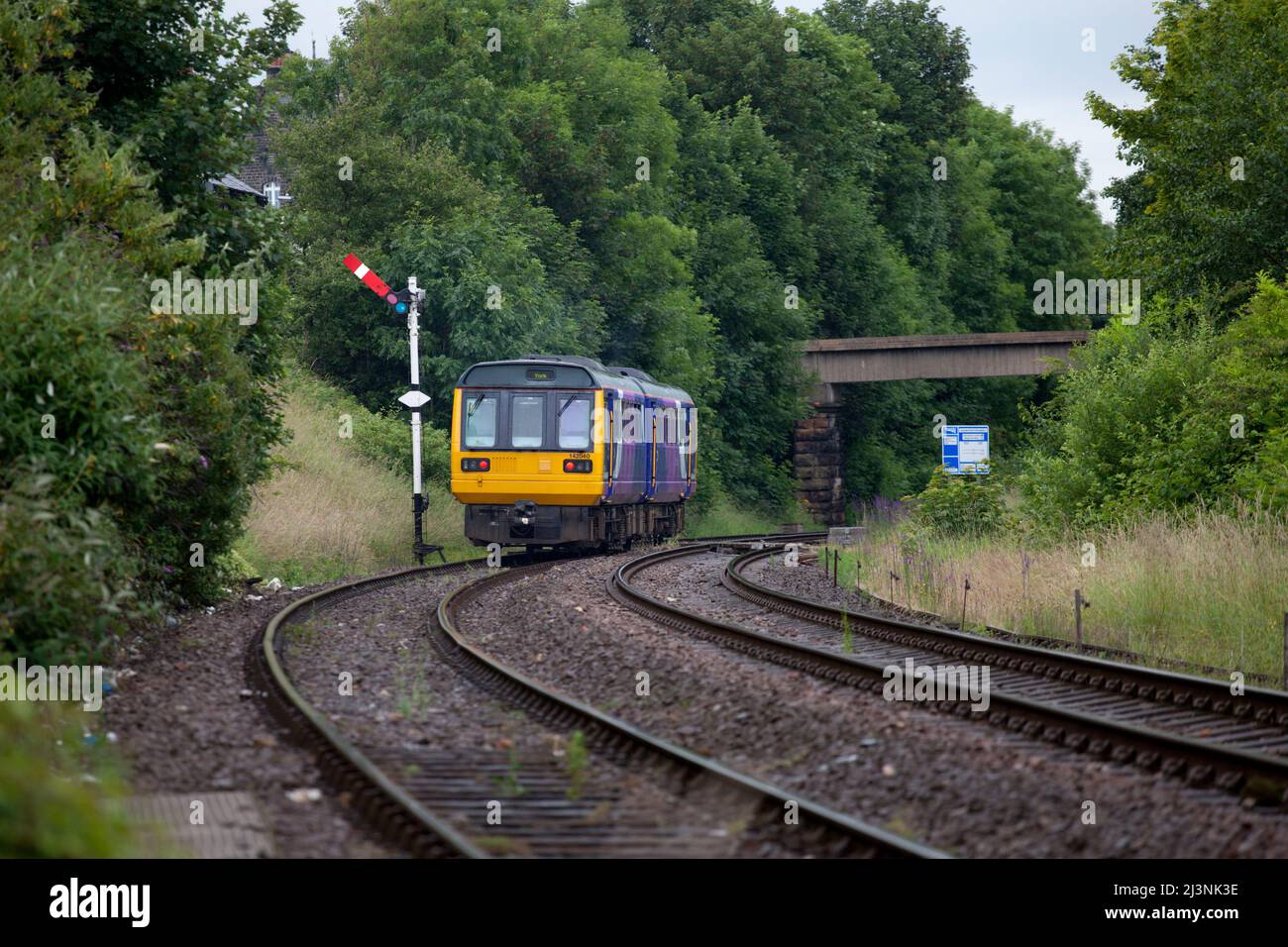 Northern Rail class 142 pacer train 142040 passing semaphore signals departing from Harrogate Stock Photo
