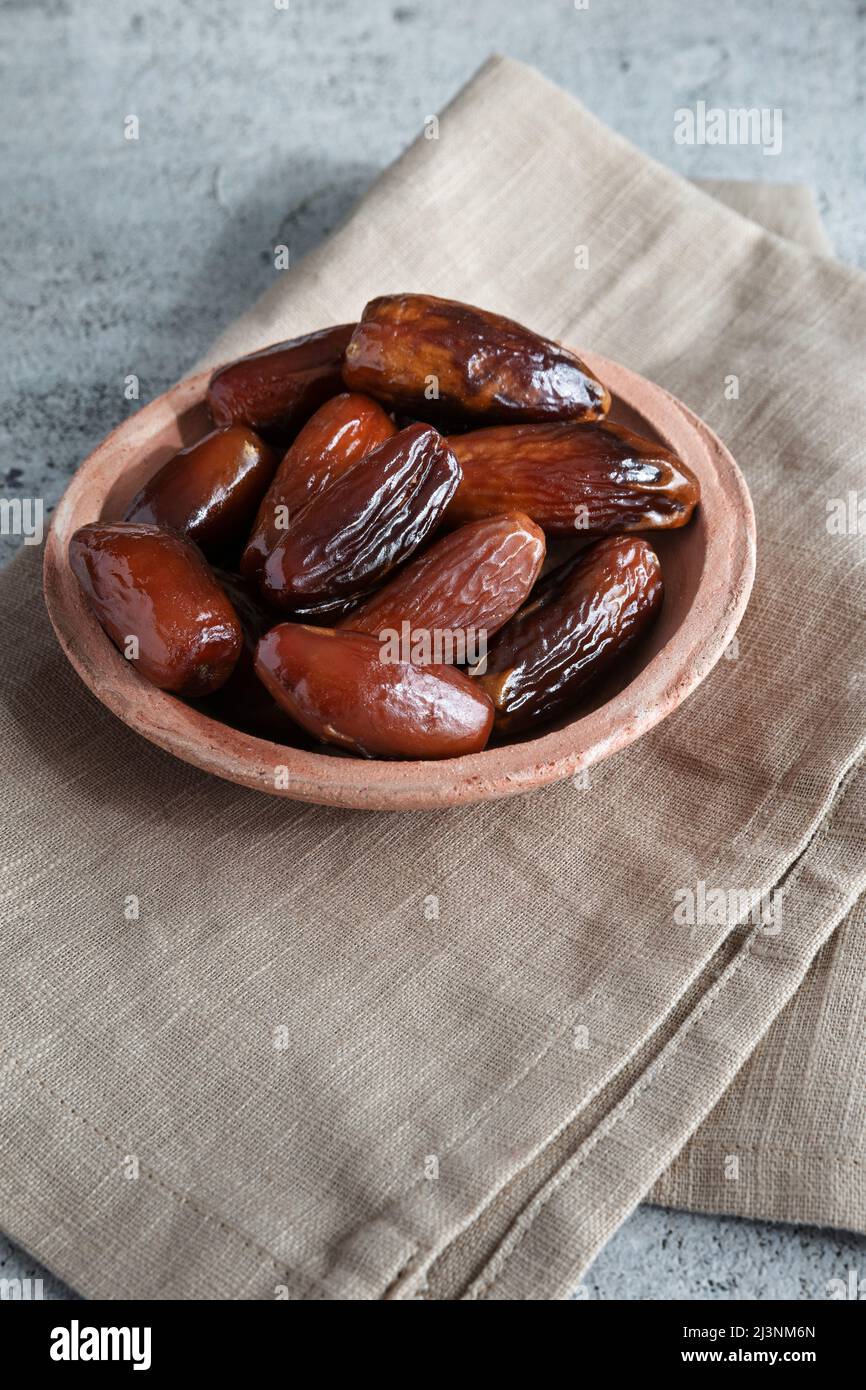 Algerian dates deglet nour on a light background in a bowl Stock Photo