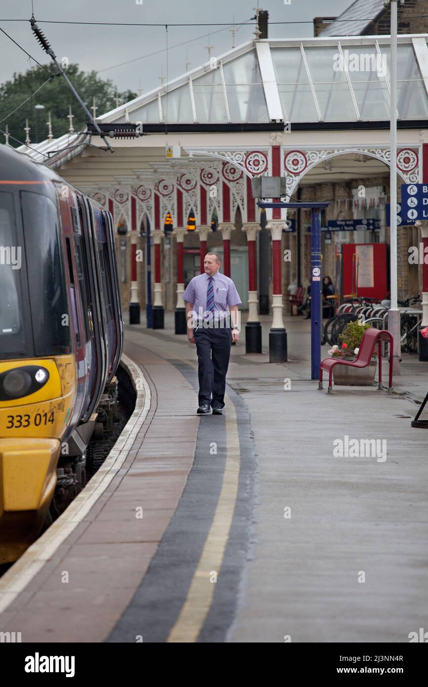 Train driver about to board a Northern rail class 333 electric train at