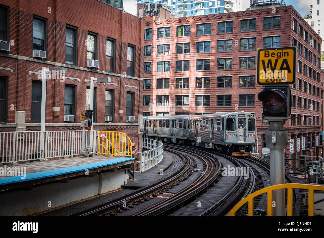 Chicago : October 11, 2018, Train on elevated tracks within buildings at the Loop, Glass and Steel bridge between buildings - Chicago City Center - Ch Stock Photo