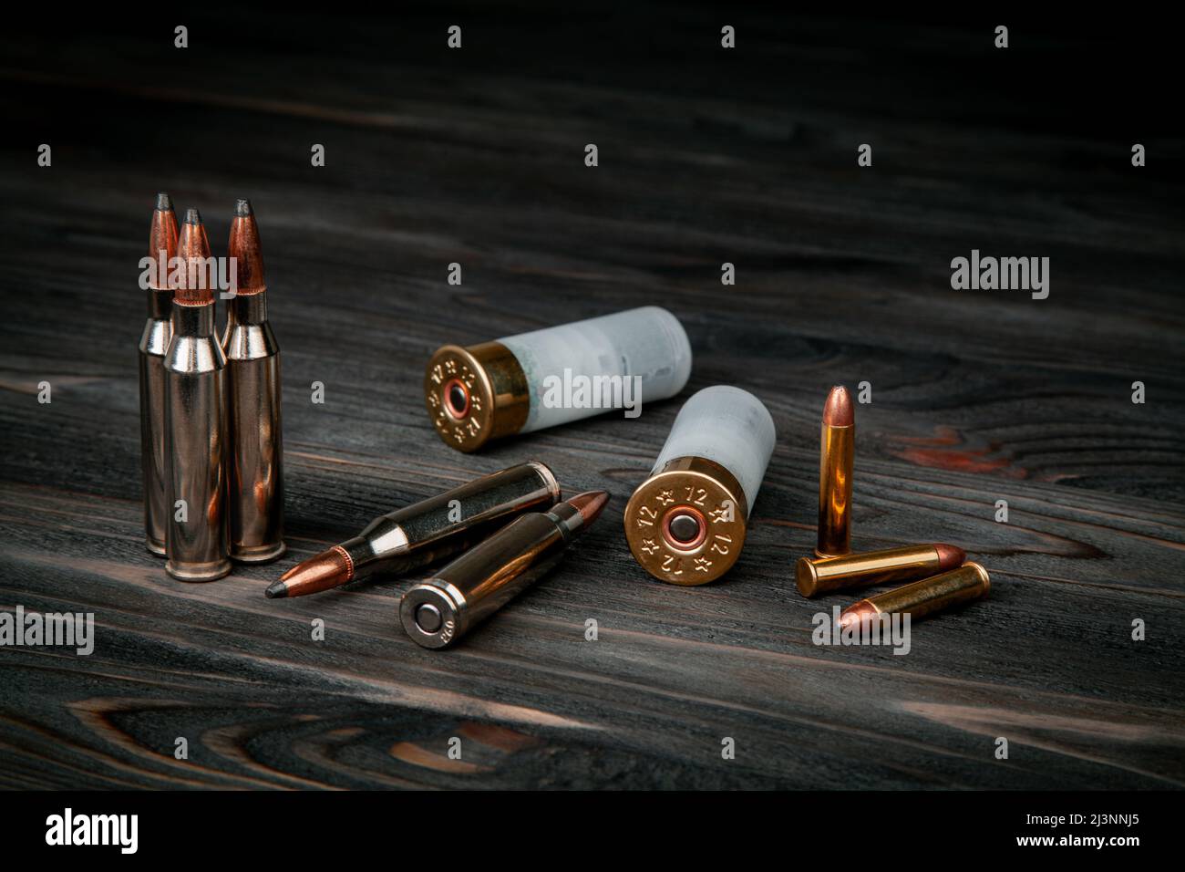 Various types of ammunition on a wooden surface. Cartridges for weapons