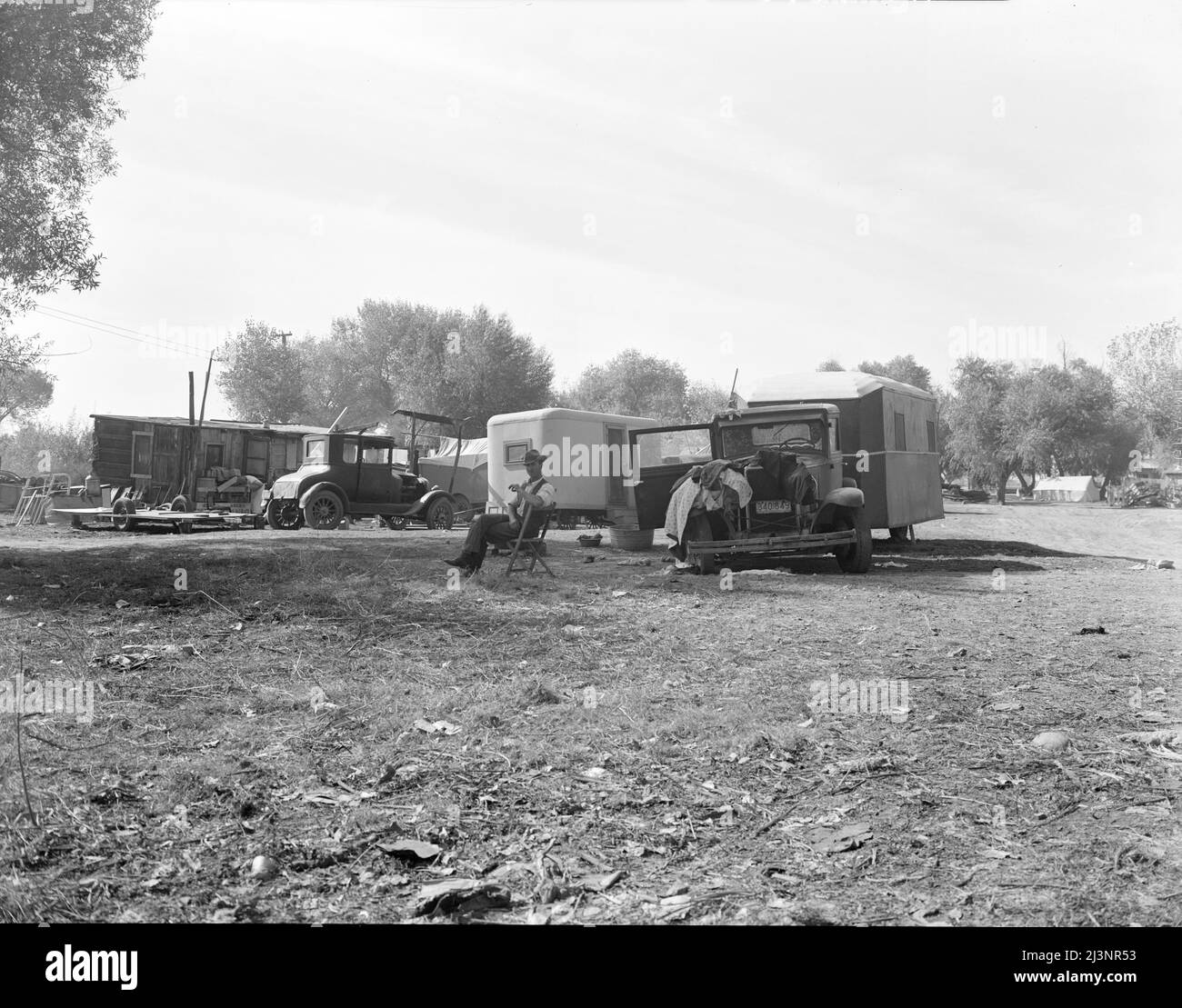 Squatter camp. Outskirts of Bakersfield, California. Note number of auto trailers and trailer being constructed on left. Stock Photo