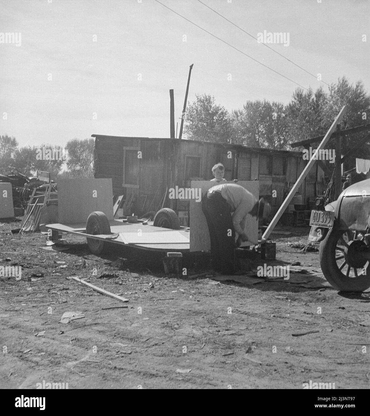 Building an auto trailer in a squatter camp. Outskirts of Bakersfield, California. Stock Photo