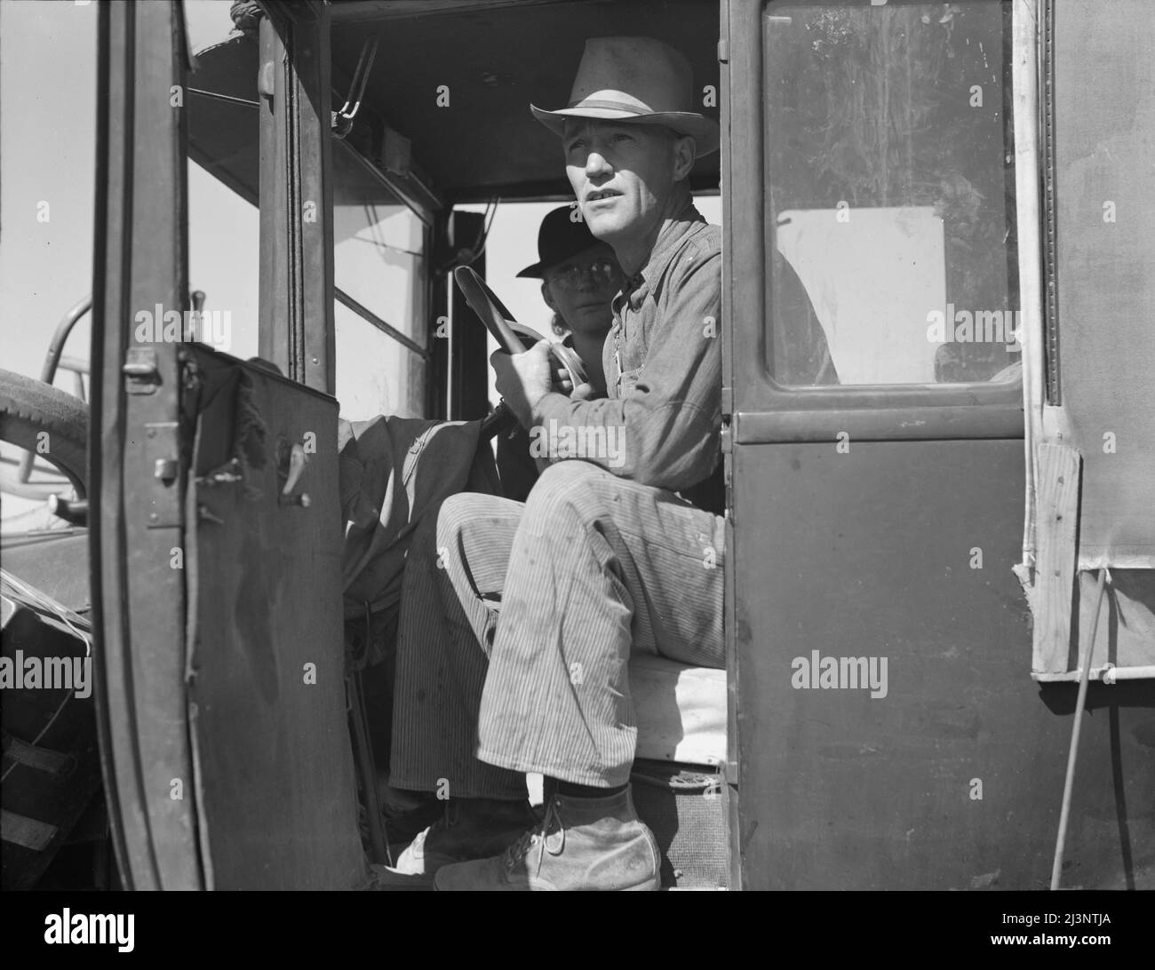 Carrot pullers from Texas. Texas farmer on edge of carrot field. In California for two weeks, migrating after three years of crop failures. Combined earnings, man and wife tying carrots: One dollar and twelve cents a day. Stock Photo