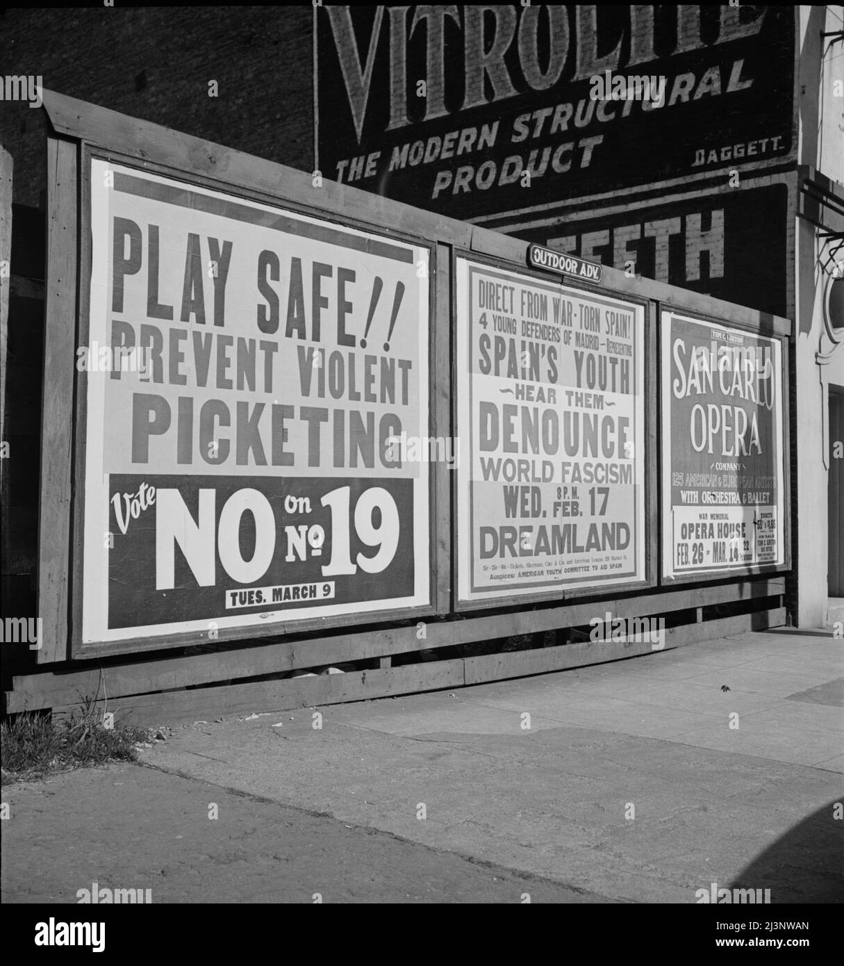 Signboards in San Francisco, California. ['Play Safe!! Prevent Violent Picketing - Vote No on No,19; Tues March 9'. 'Direct from War-Torn Spain - 4 Young Defenders of Madrid representing Spain's Youth - Hear Them Denounce World Fascism - 8pm Wed. Feb. 17th, Dreamland']. Stock Photo