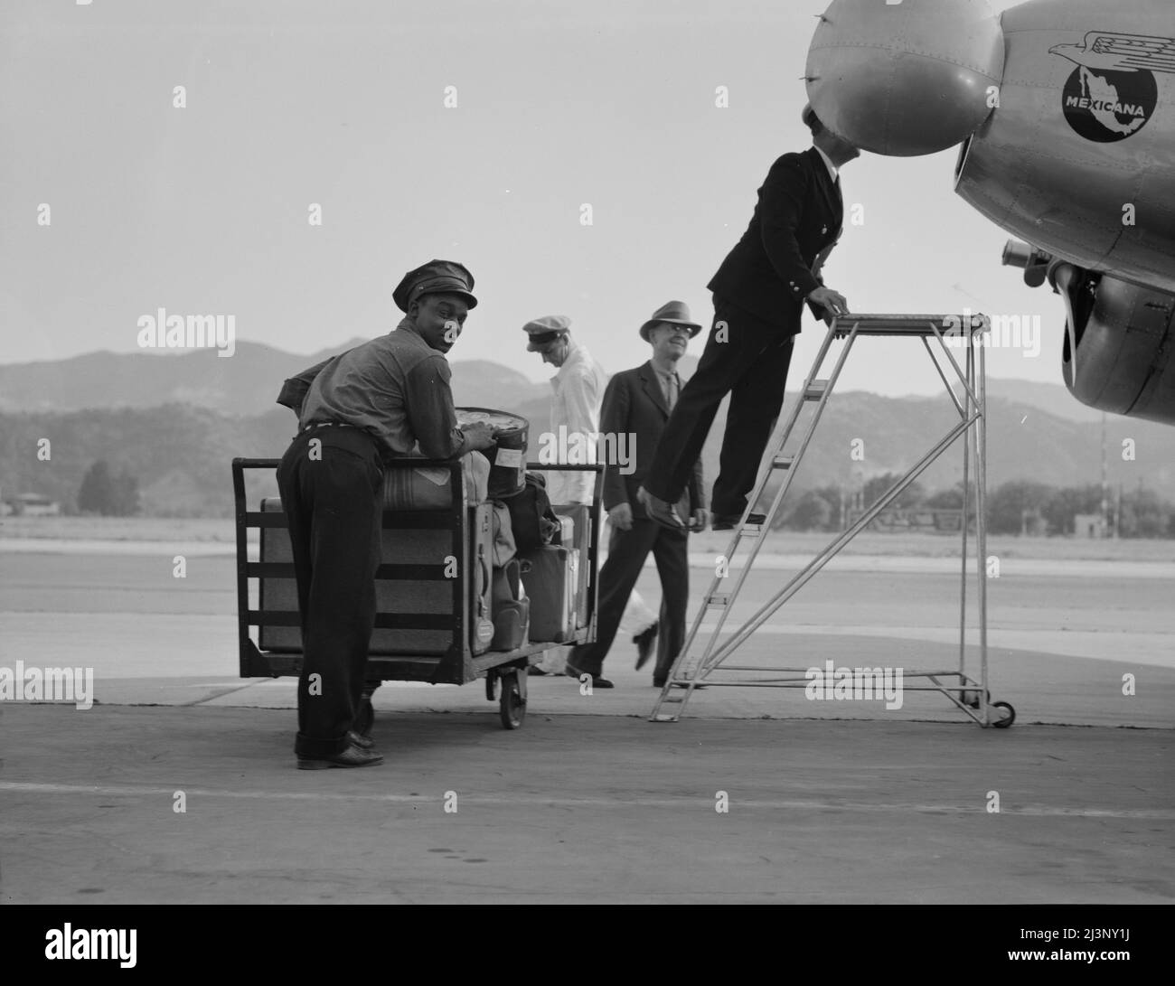 Department of Agriculture plant quarantine inspectors examining Pan American Airways plane from Mexico on its arrival at the Glendale Airport, California. Stock Photo