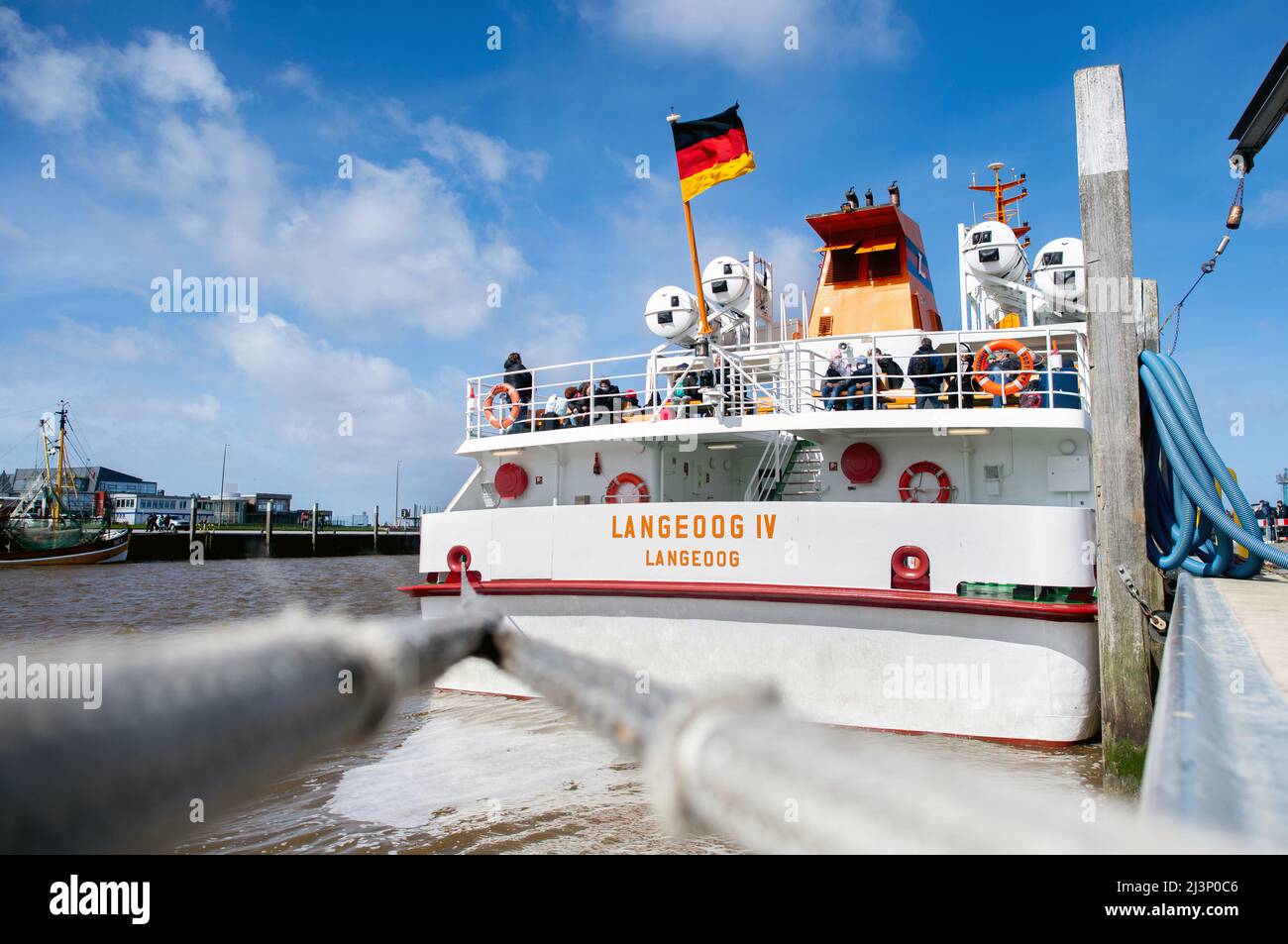 Bensersiel, Germany. 09th Apr, 2022. The ferry ship 'Langeoog IV' lies on a quay wall in the harbor before crossing to the island of Langeoog. With the start of the vacations in many German states, including North Rhine-Westphalia, many Easter holidaymakers traveled to the coast and the East Frisian islands on Saturday. Credit: Hauke-Christian Dittrich/dpa/Alamy Live News Stock Photo